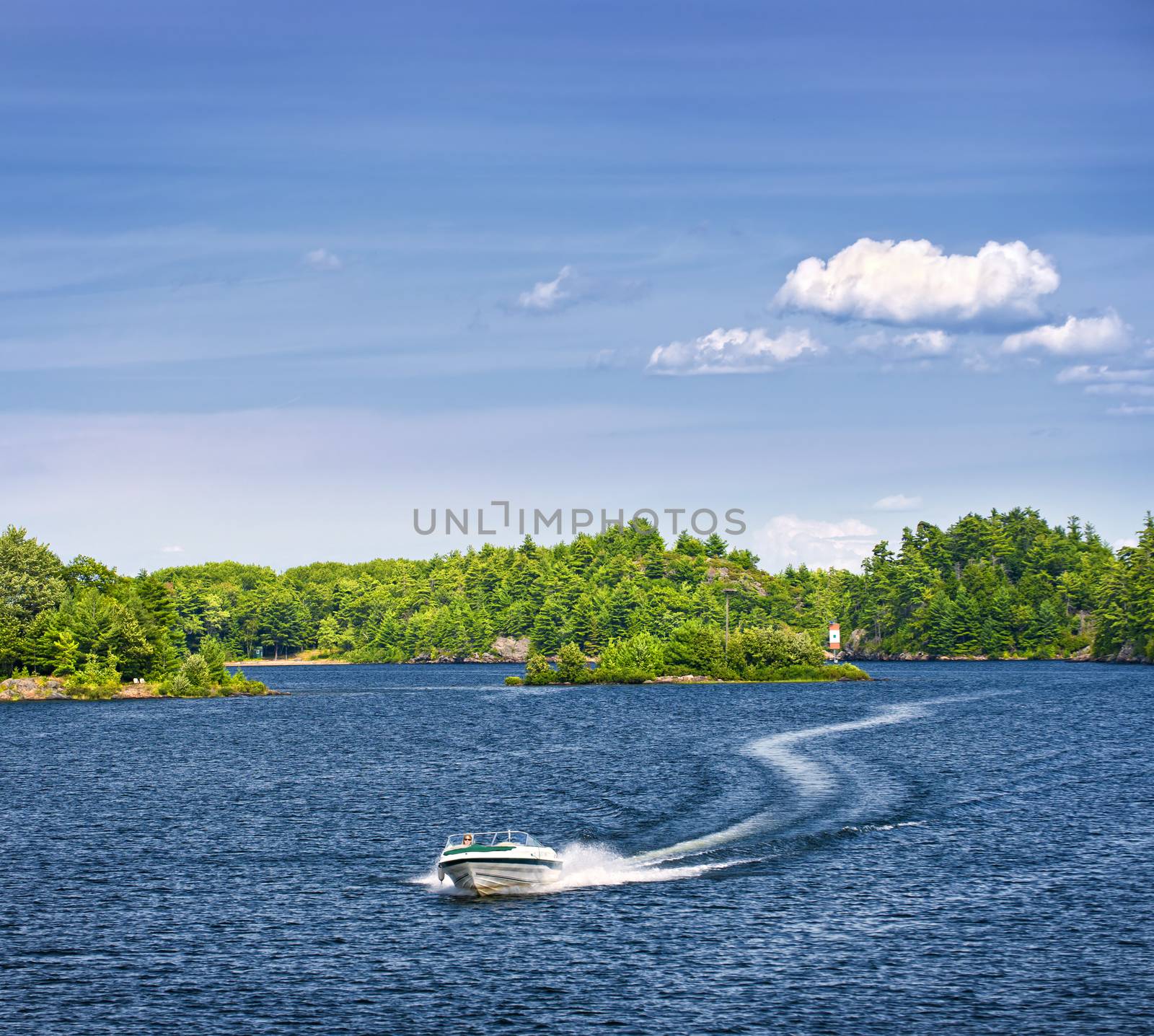 Woman piloting motorboat on lake in Georgian Bay, Ontario, Canada