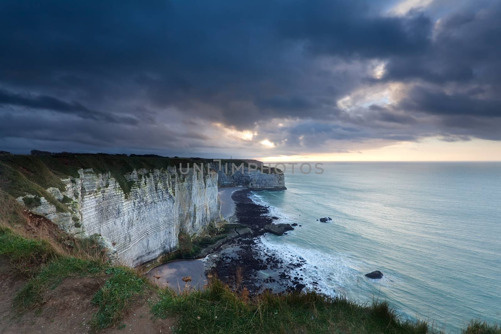 stormy clouded sky over cliffs in ocean by catolla