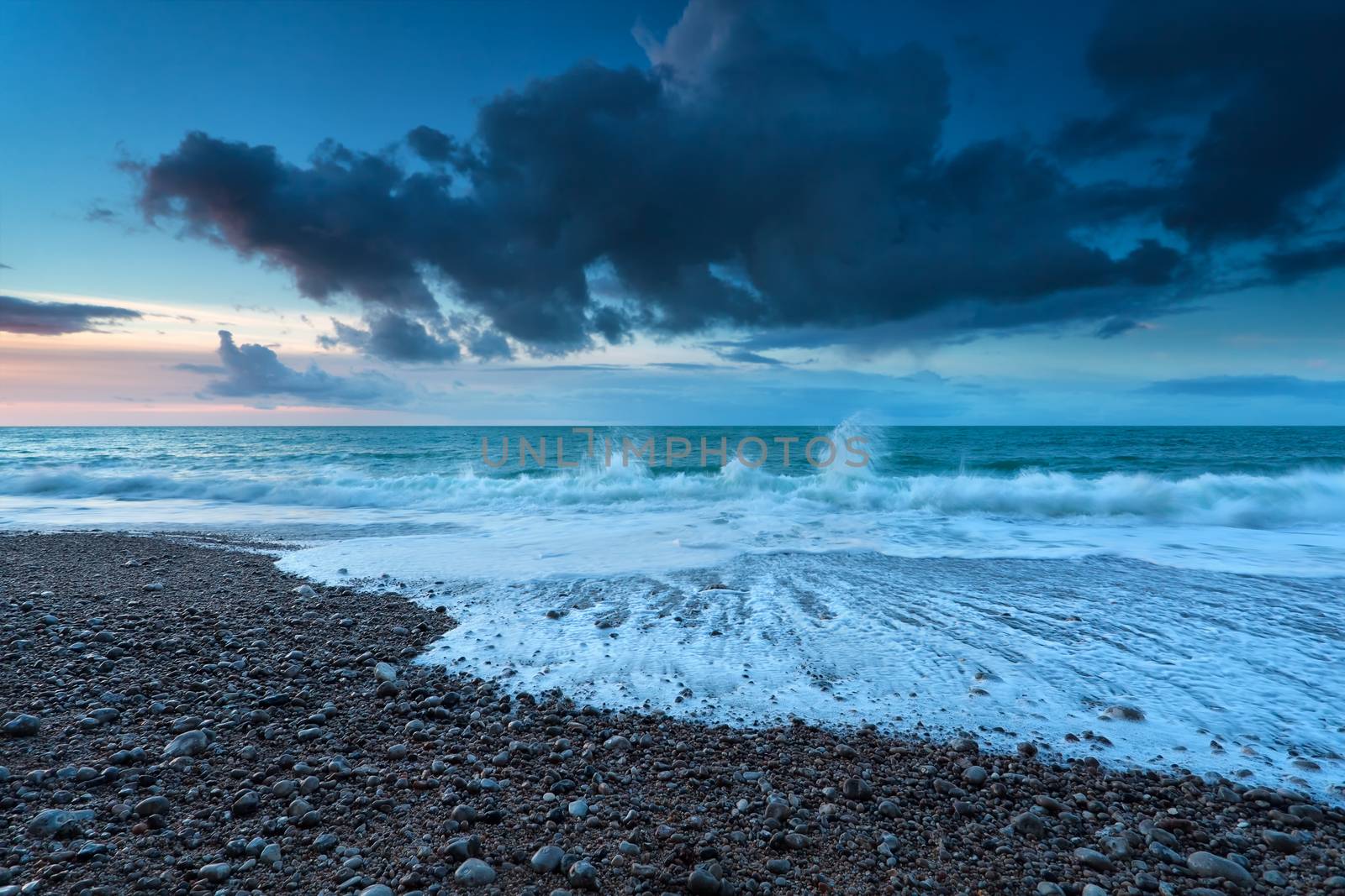 ocean waves on rocky beach, Etretat, Normandy, France
