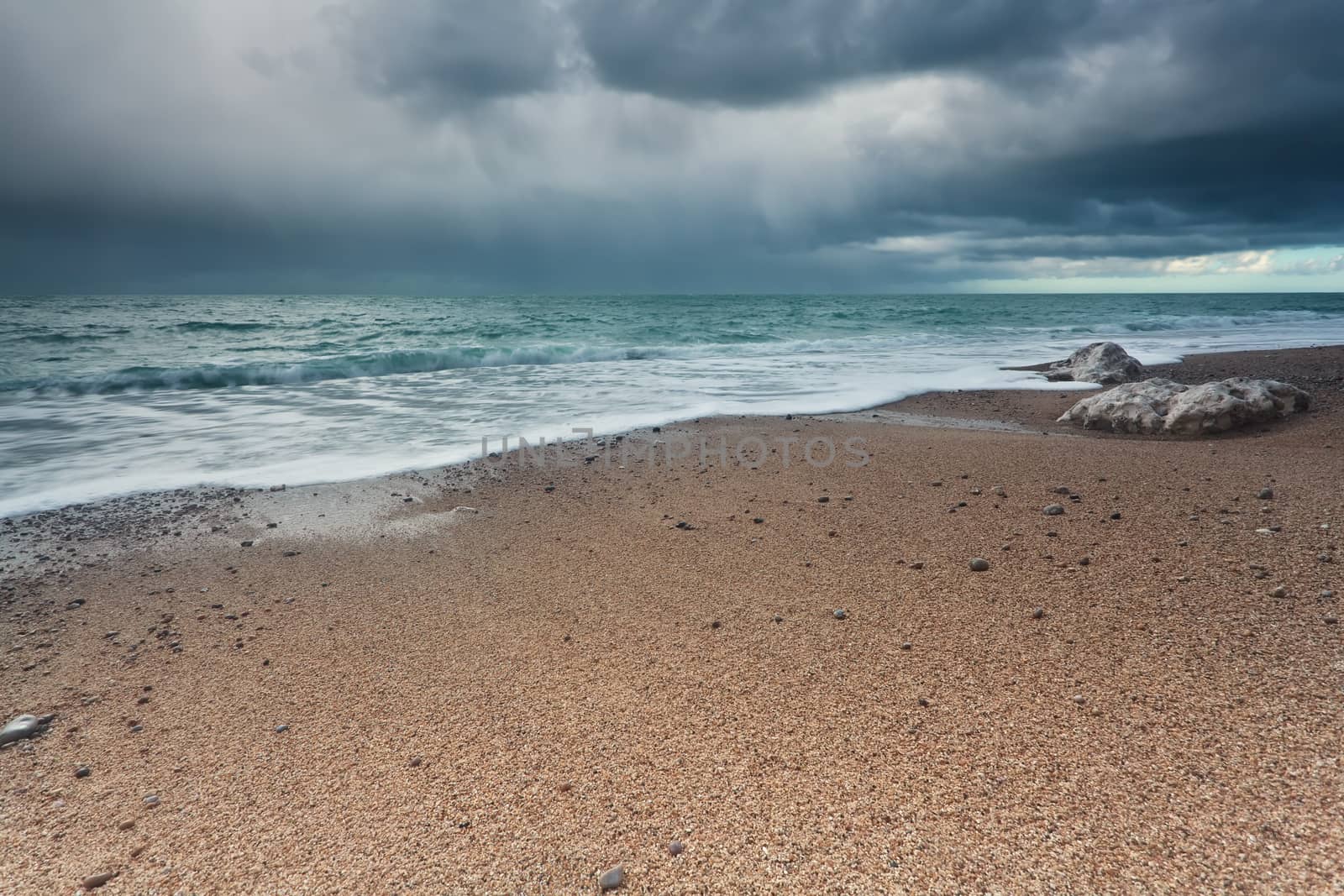stormy sky over rock beach in Atlantic ocean by catolla