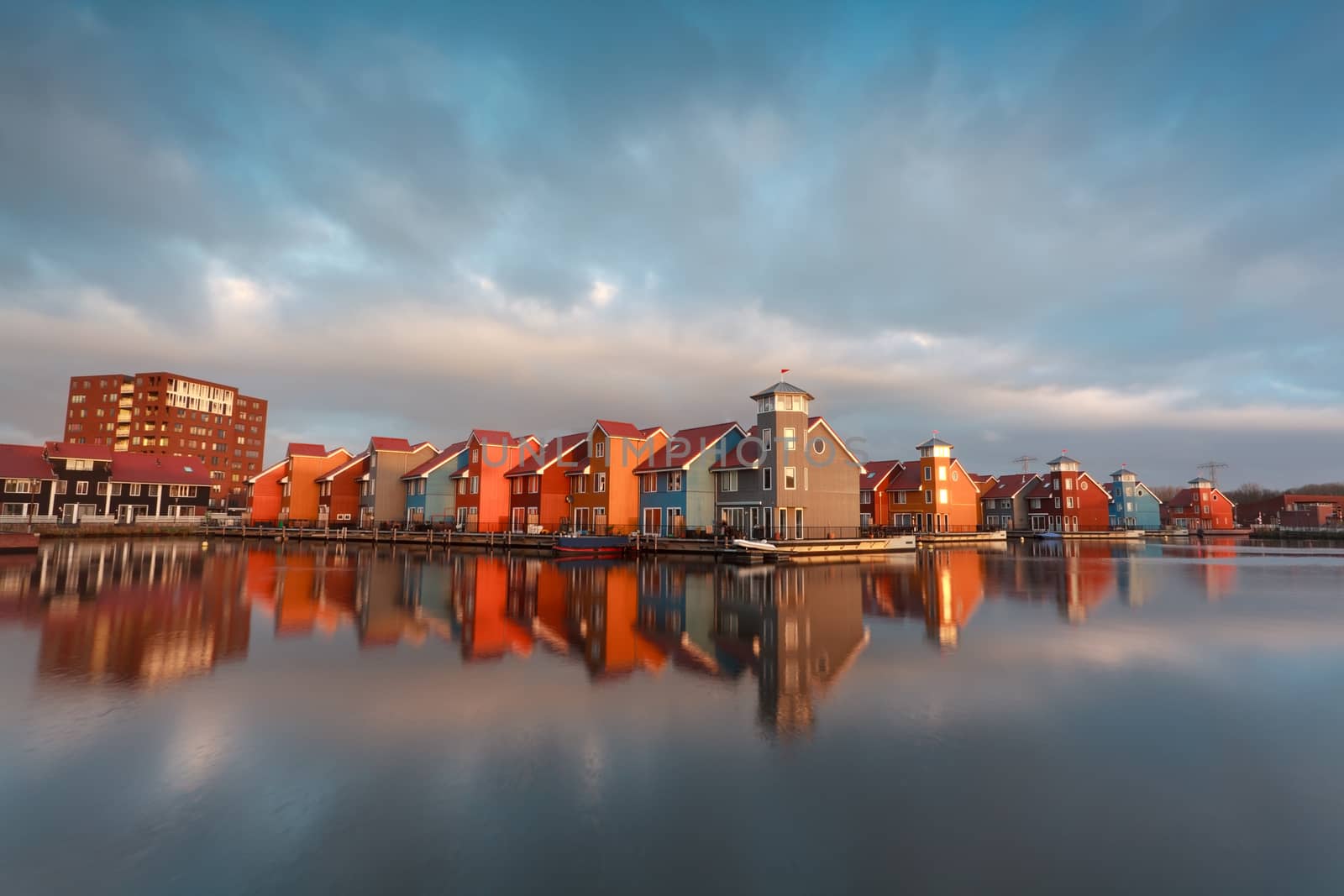 colorful buildings on water in morning sunlight, Groningen, Netherlands