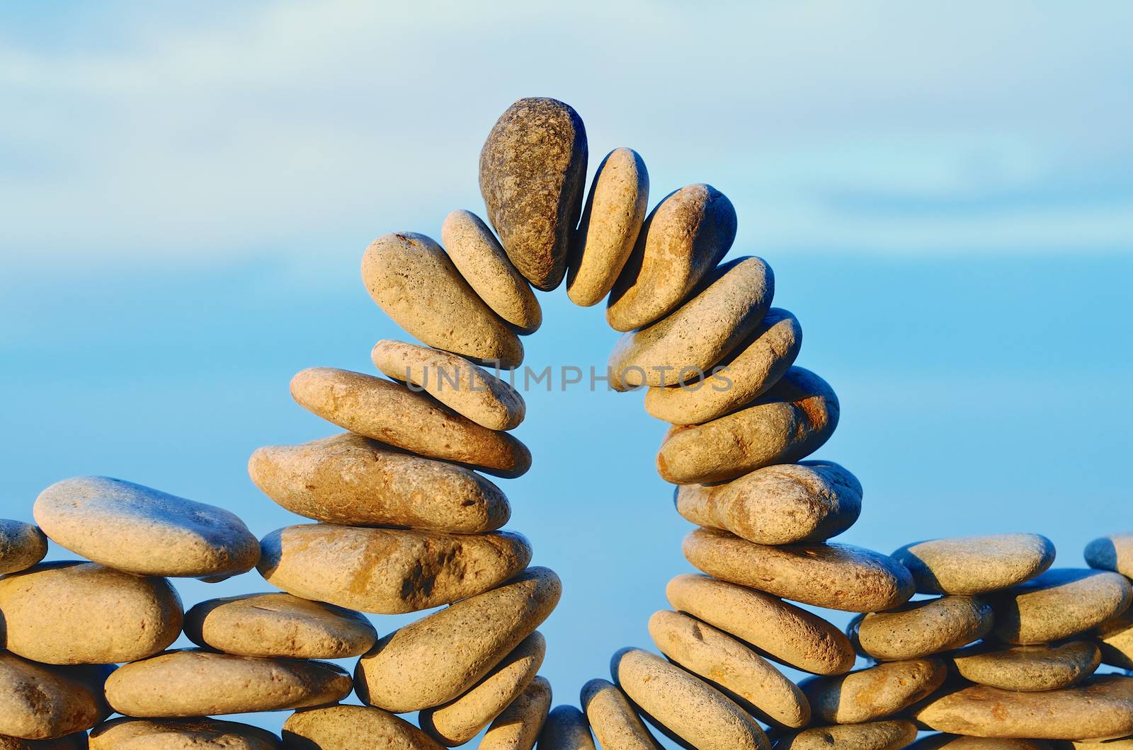 Stone arch between the pebbles on the seacoast