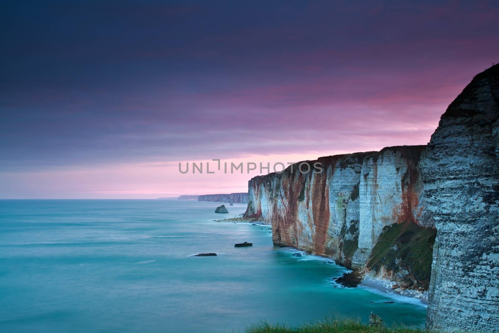 purple sunrise over Atlantic ocean and cliffs by catolla