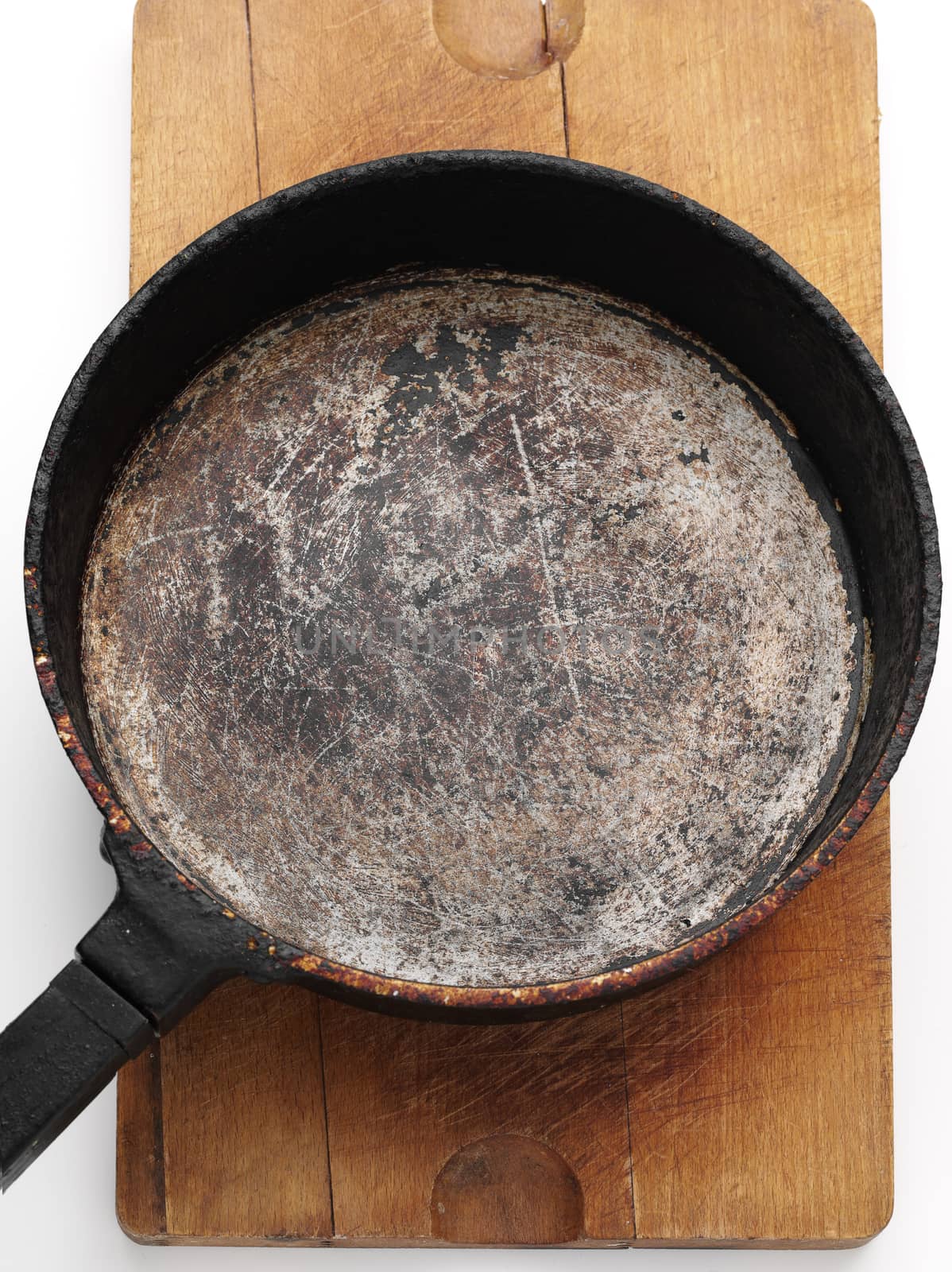 old style frying pan on wooden plank