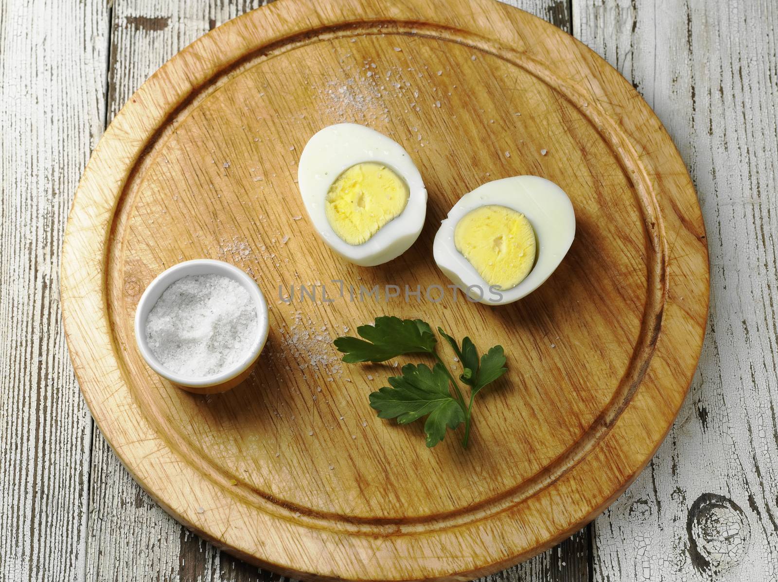 hard boiled egg on wooden board with salt