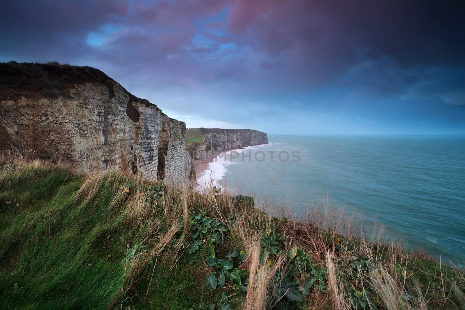 sunrise over cliff in ocean, Etretat, Normandy, France