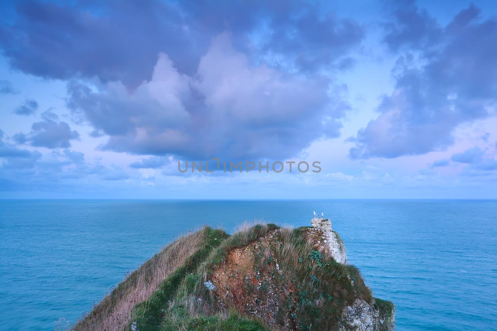 beautiful clouds on sunrise sky over ocean, Etretat, France