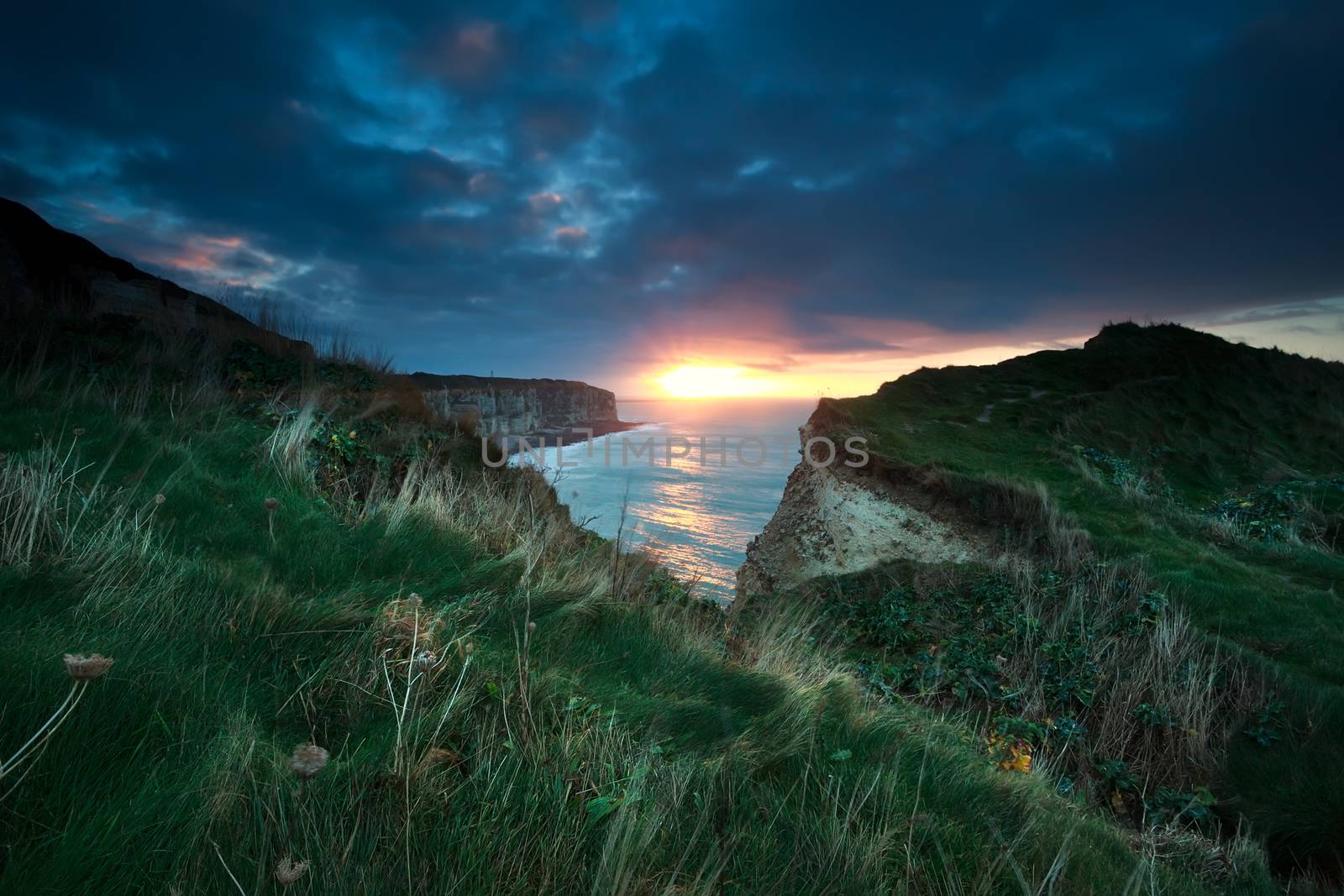 sunset over cliffs in ocean, Etretat, France