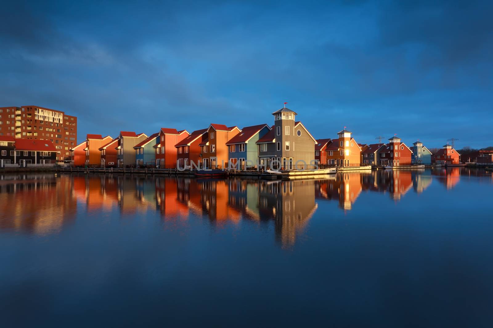 multicolor buildings on water in sunshine, Groningen, Netherlands