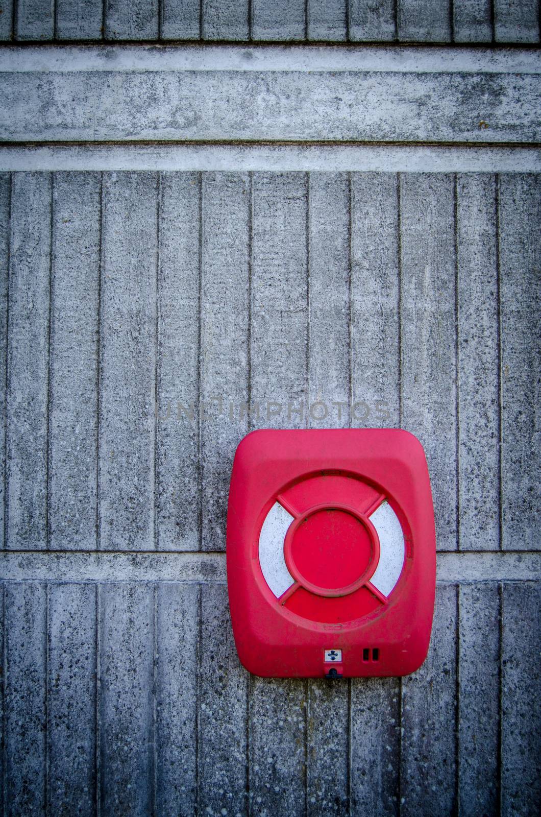 Red Life Preserver Against Concrete Wall