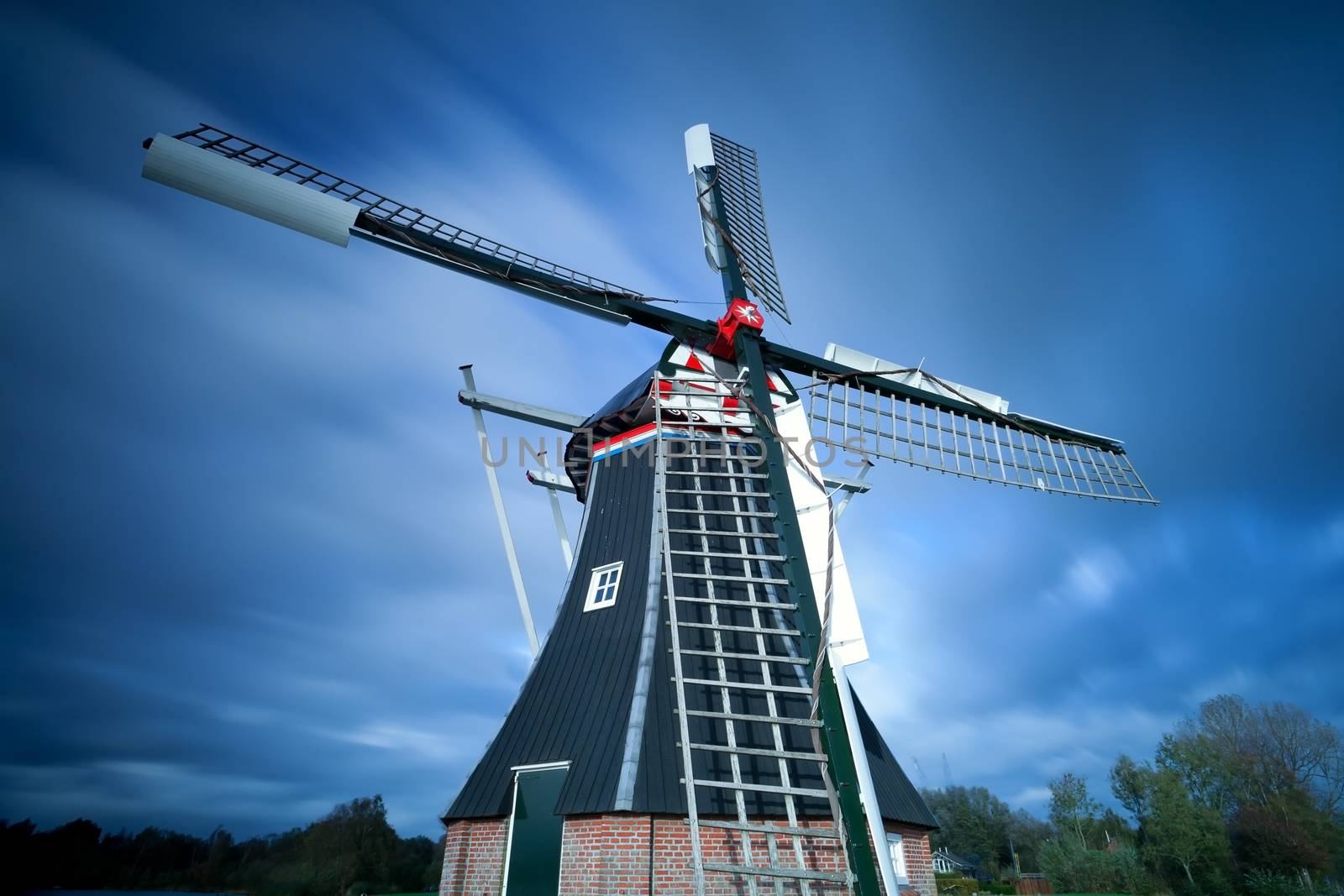 Dutch windmill over sky by catolla