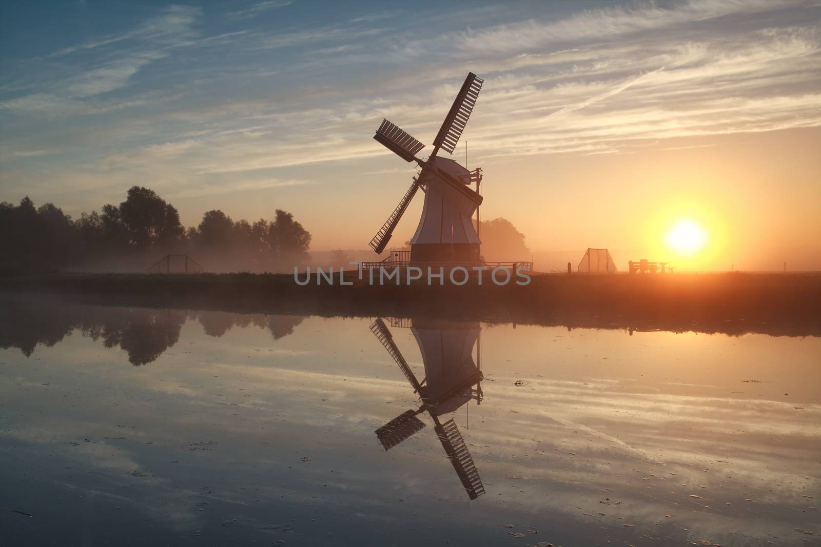 sunrise behind Dutch windmill by catolla