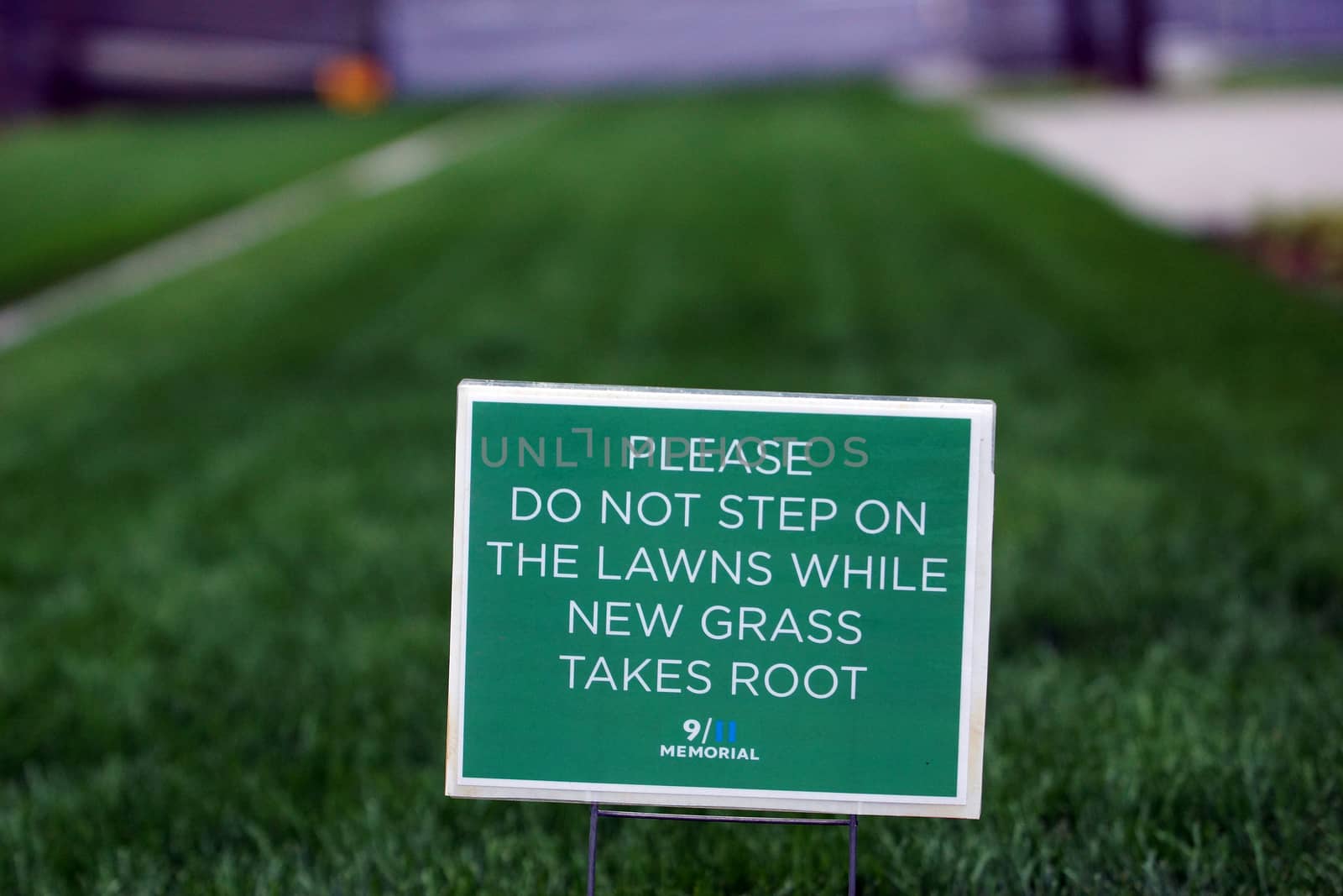 A sign asking to keep off the fresh grass