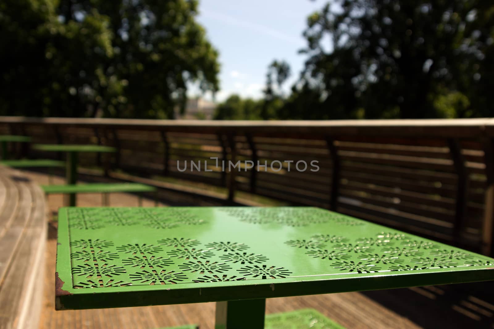 A green metal table top outside on a patio