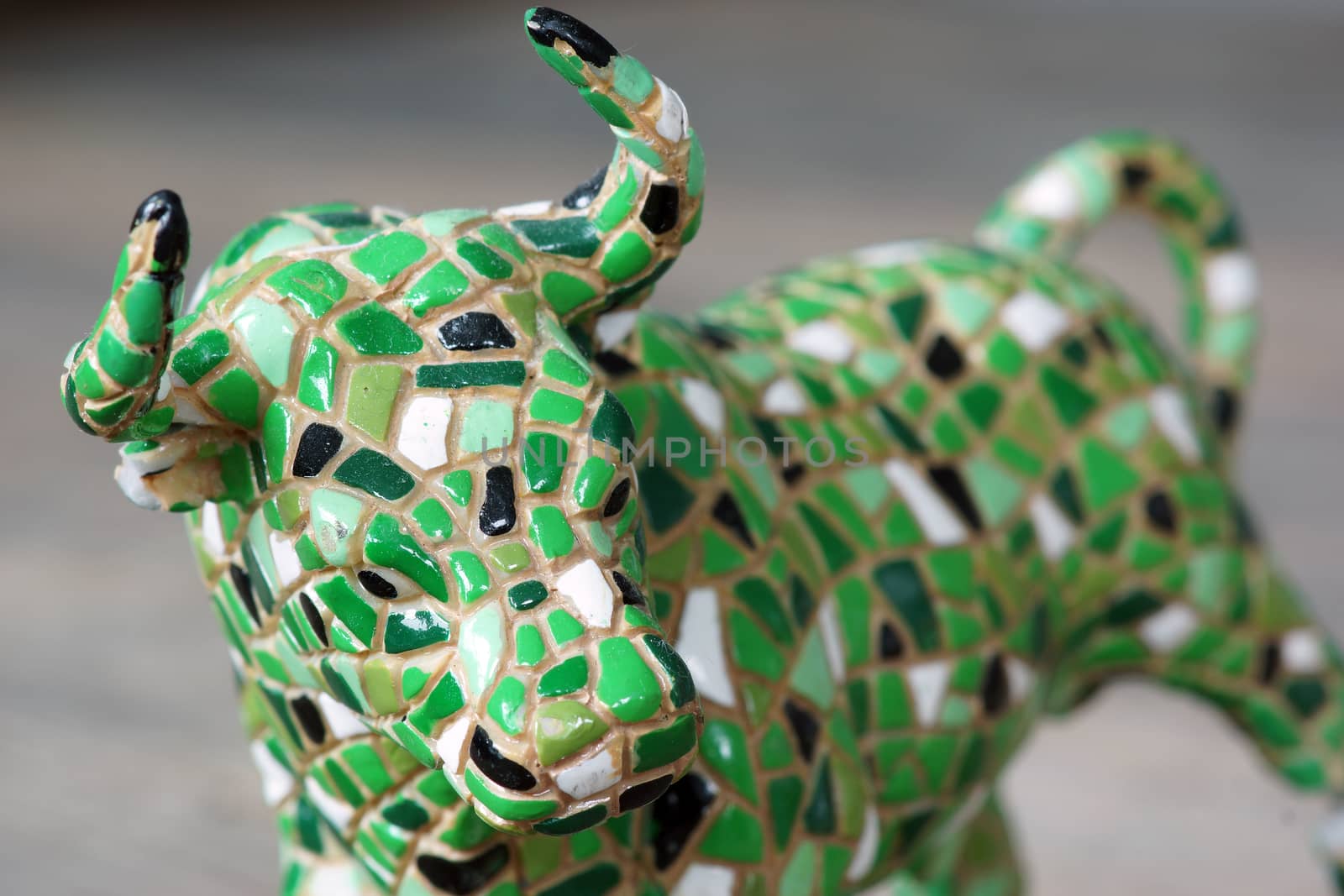 A small toy mosaic standing bull statue