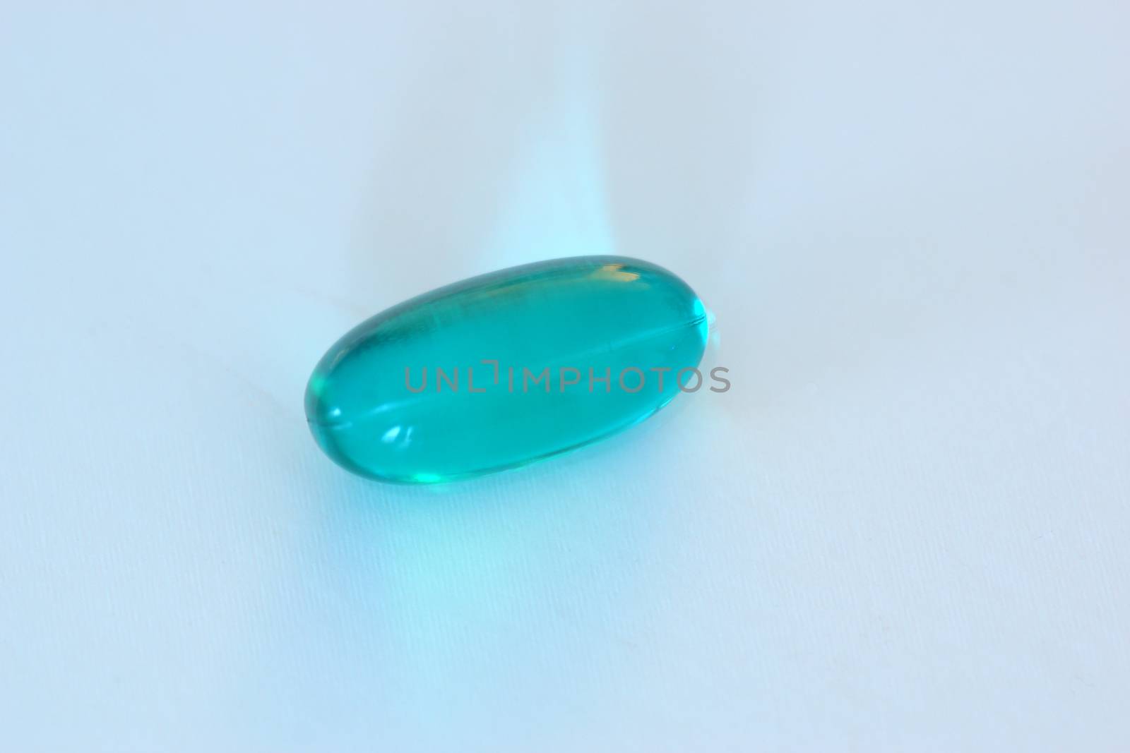 A single blue gel capsule containing medicine