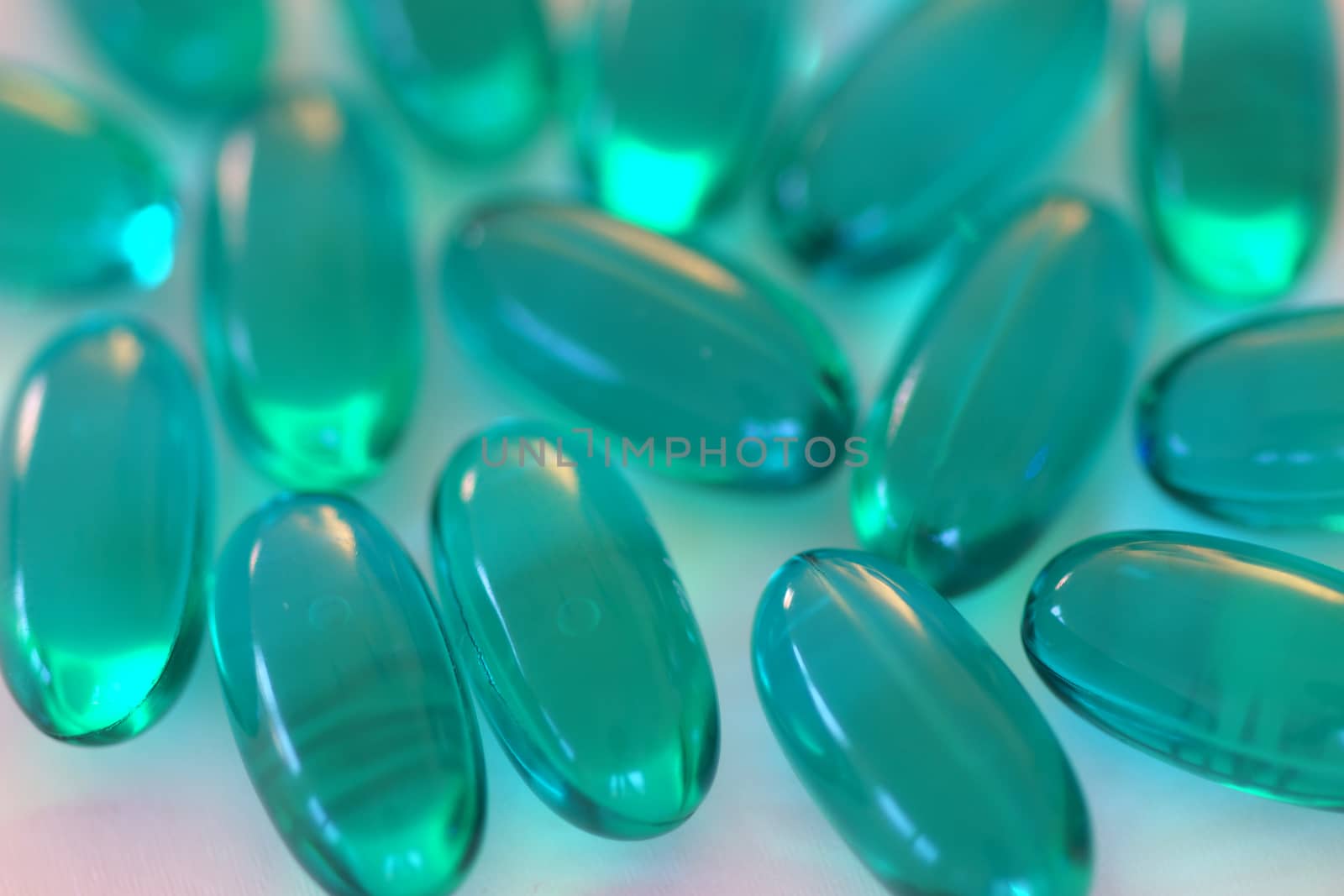 Multiple blue gel capsules containing medicine