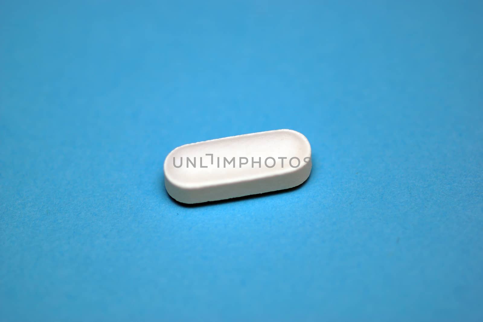 A white tablet containing prescription medicine