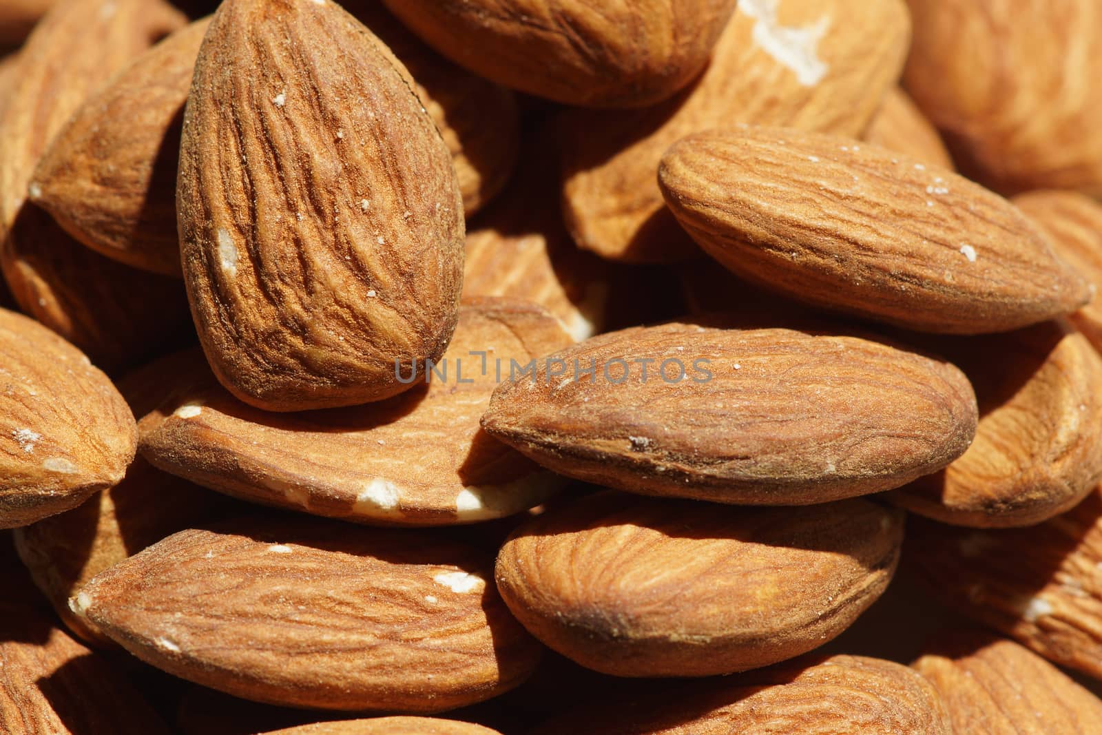 A pile of almonds as seen close up from above