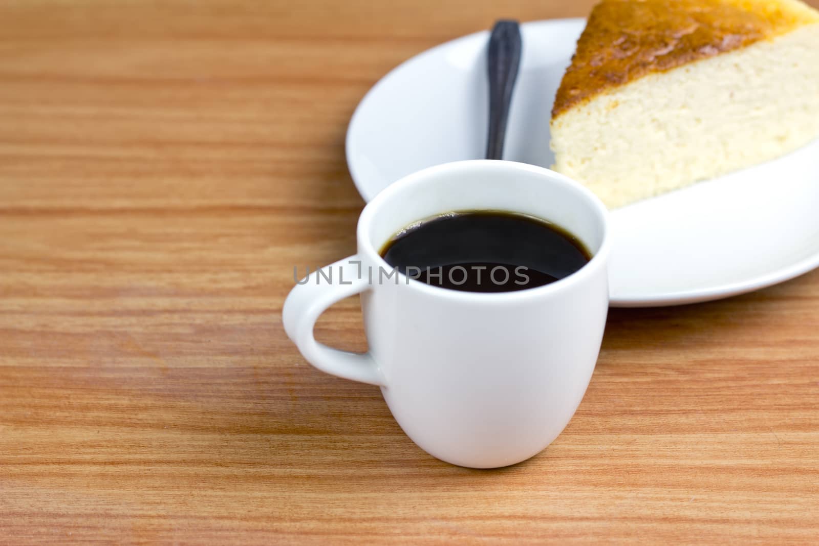 black coffee and Chesse cake on wood background