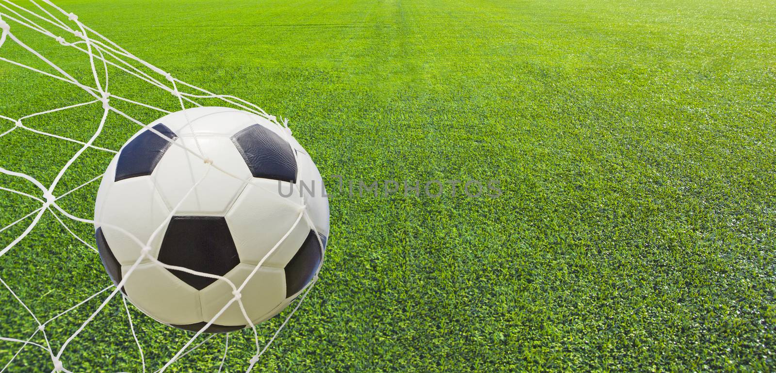 Soccer ball in a net.  by wyoosumran
