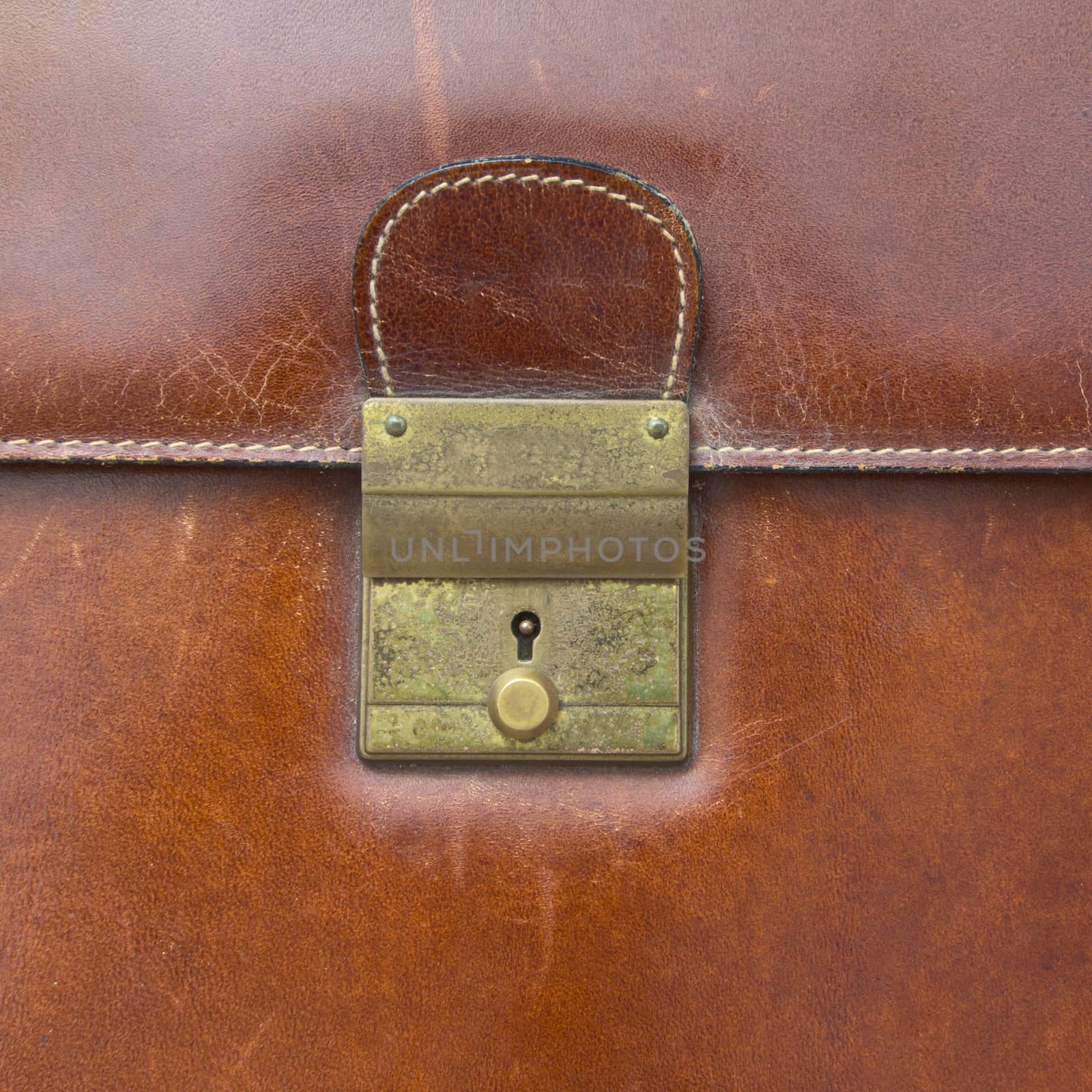 Close-up of lock on leather business case by wyoosumran