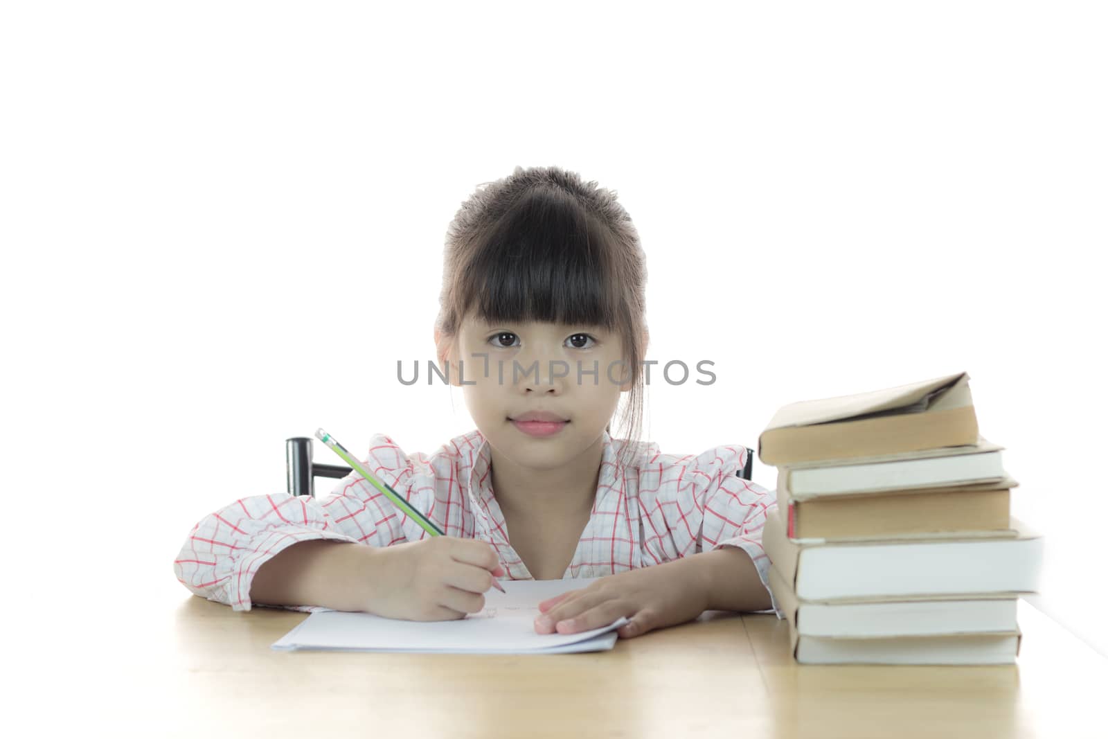 schoolgirl works on her homework by wyoosumran