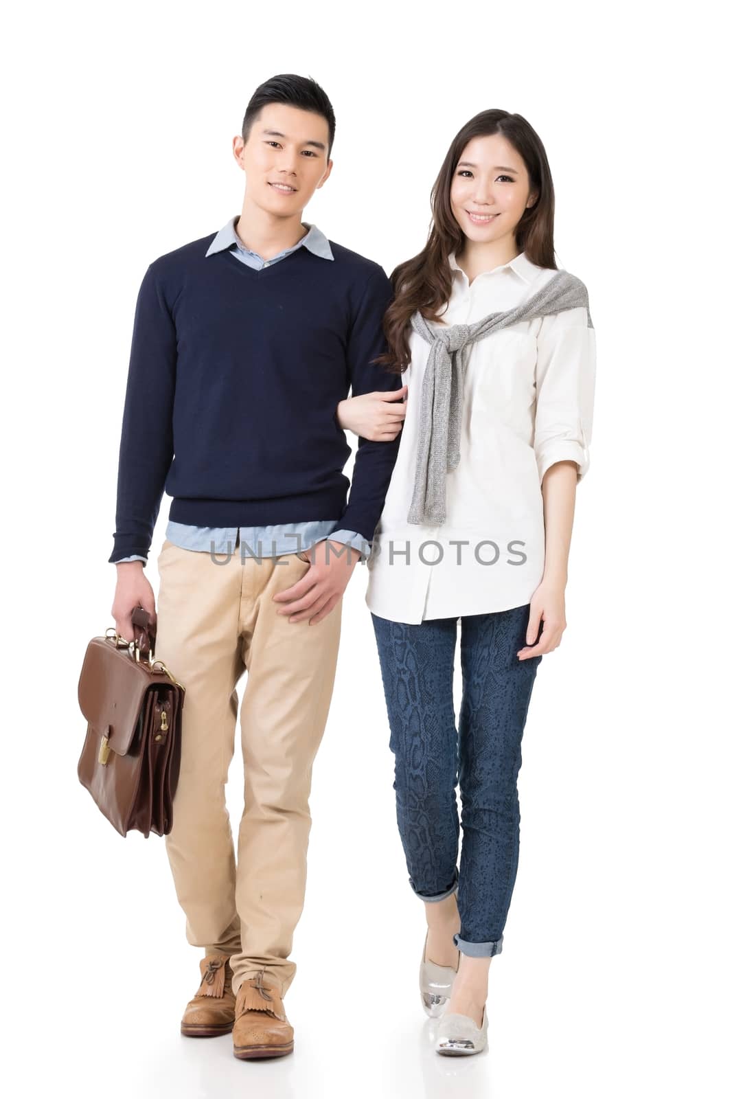 Young attractive Asian couple, full length portrait isolated on white.