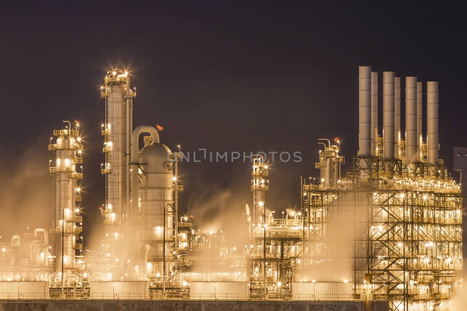 Night scene of Water vapor from cooling tower in chemical plant