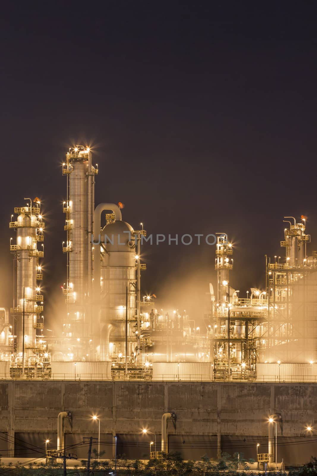 Night scene of Water vapor from cooling tower in chemical plant