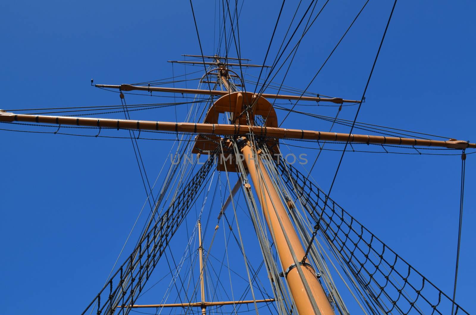 A large wooden mast on a British sloop ship.