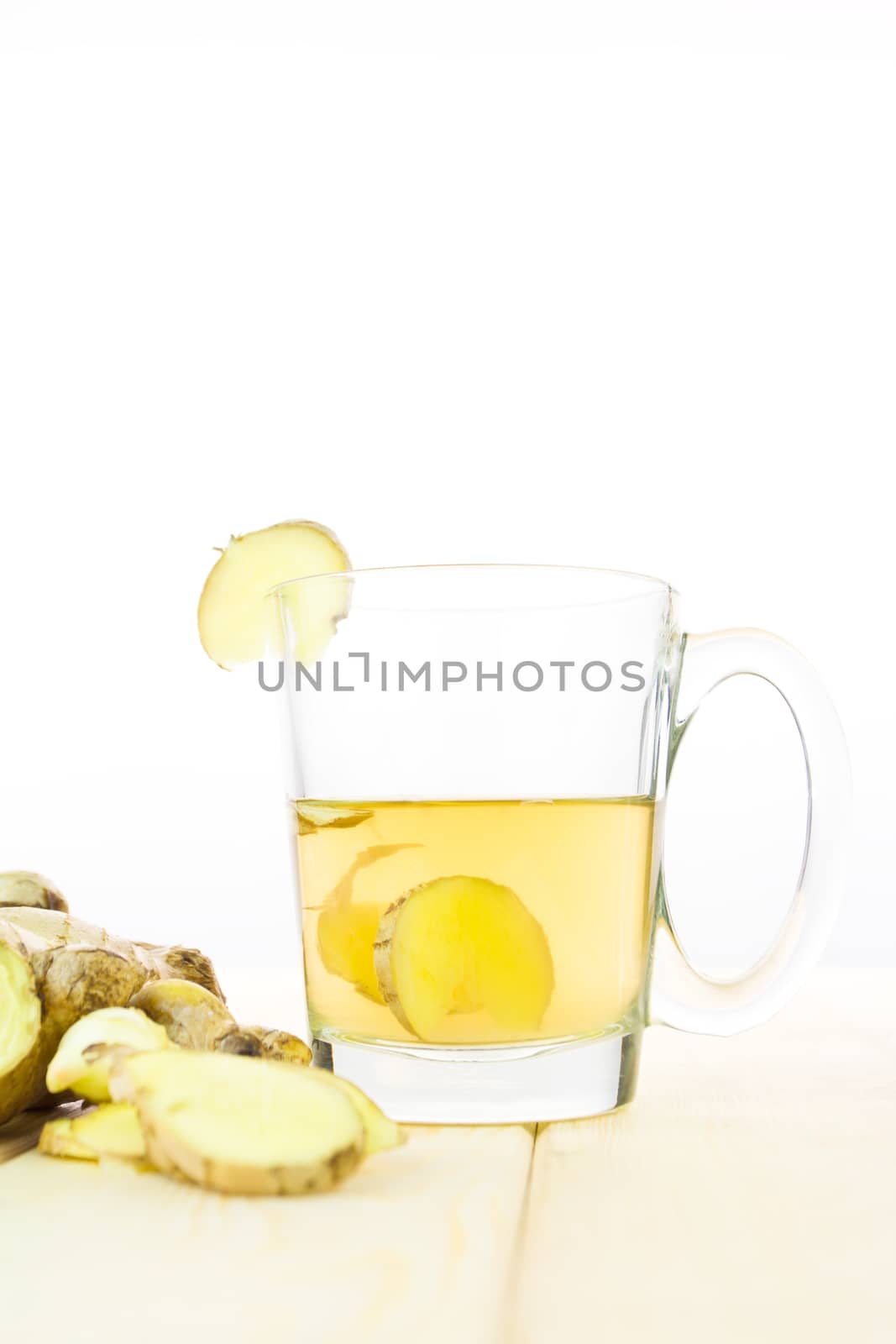 Healthy ginger tea with fresh ginger on wood background