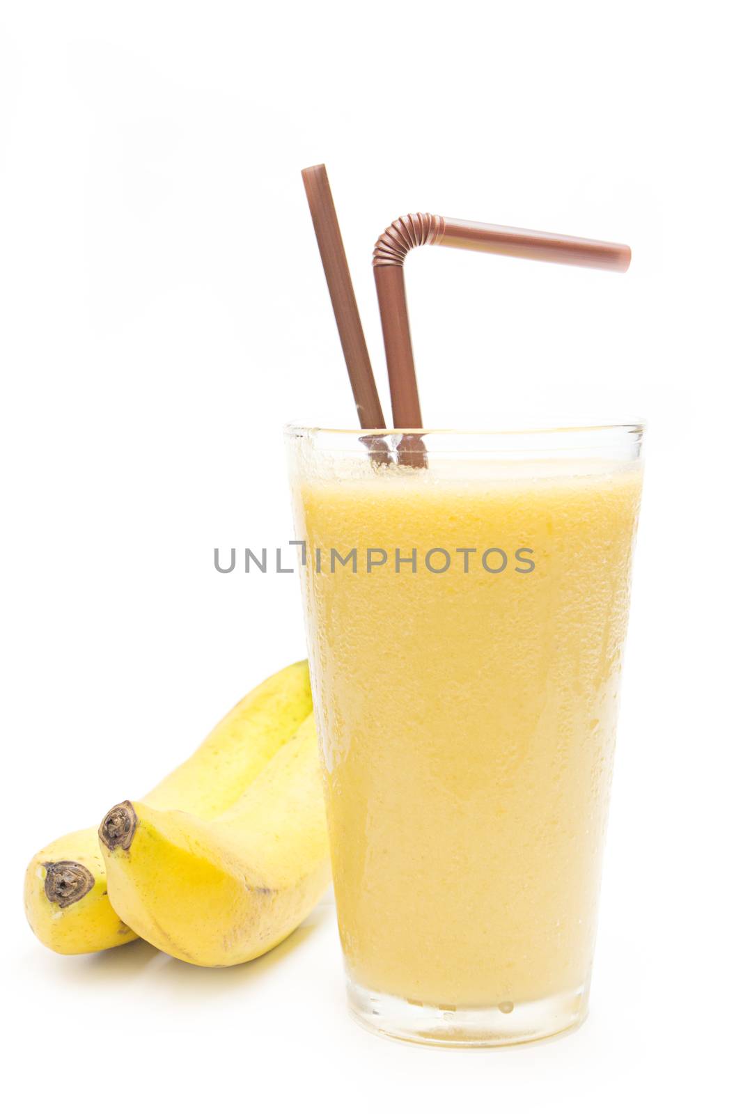 Banana smoothie in glass on white background