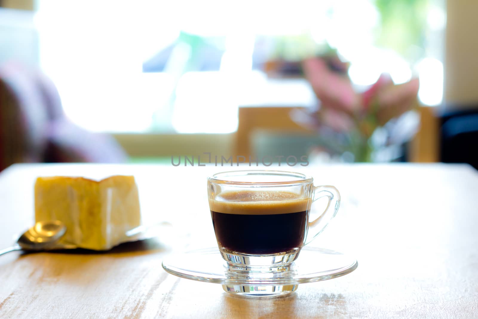 Hot coffee with cheesecake on wood