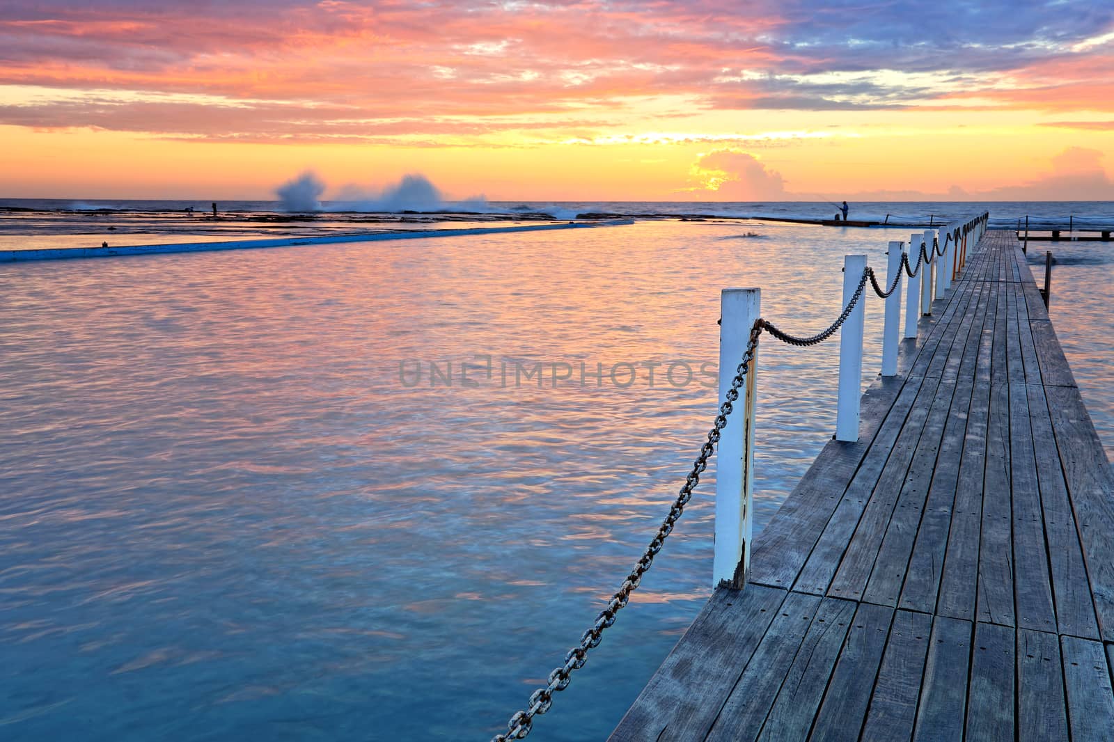 The view across Narrabeen Ocean Rock Pools and the rock shelf beyond on a spectacular sunrise morning.   The waters beckons you, 