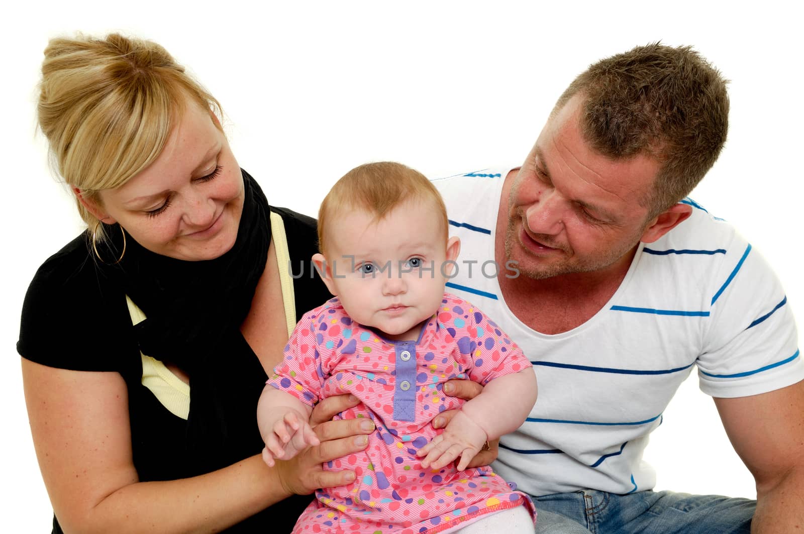 Happy family. Mother and father are looking at their sweet smiling 4 month old baby.