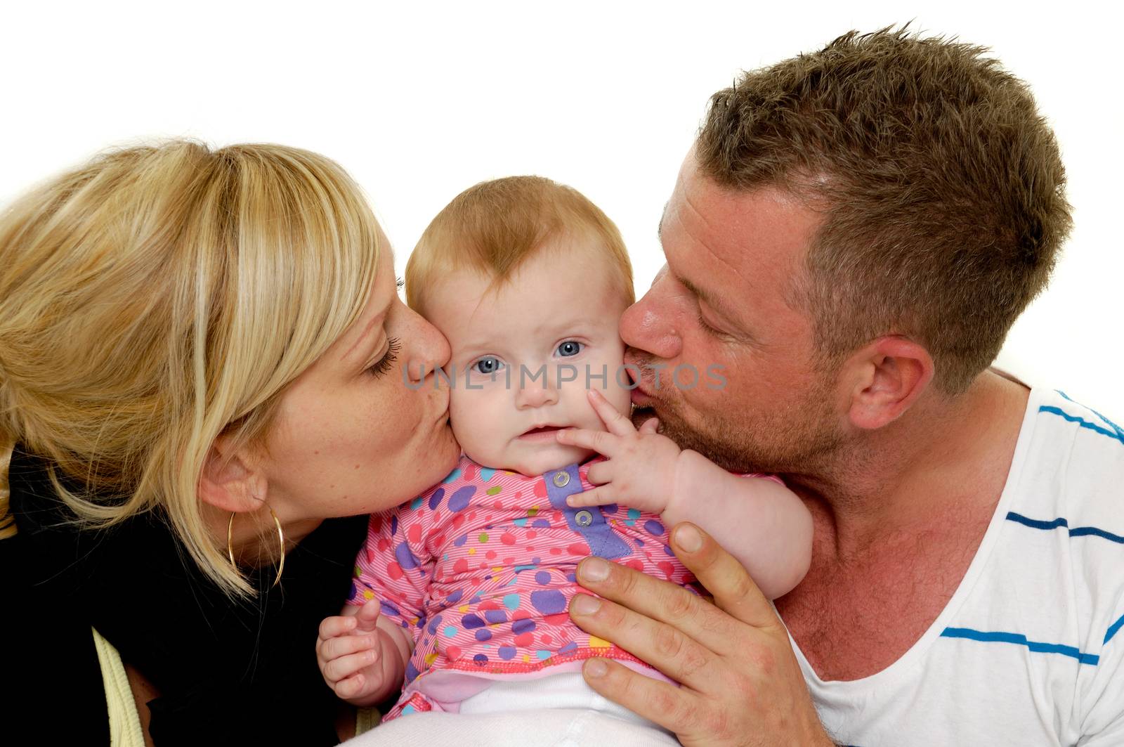 Mother and father are kissing their sweet baby 4 month old baby.