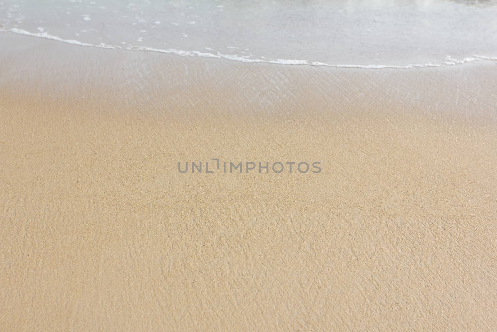 Wet sand on beach by wyoosumran