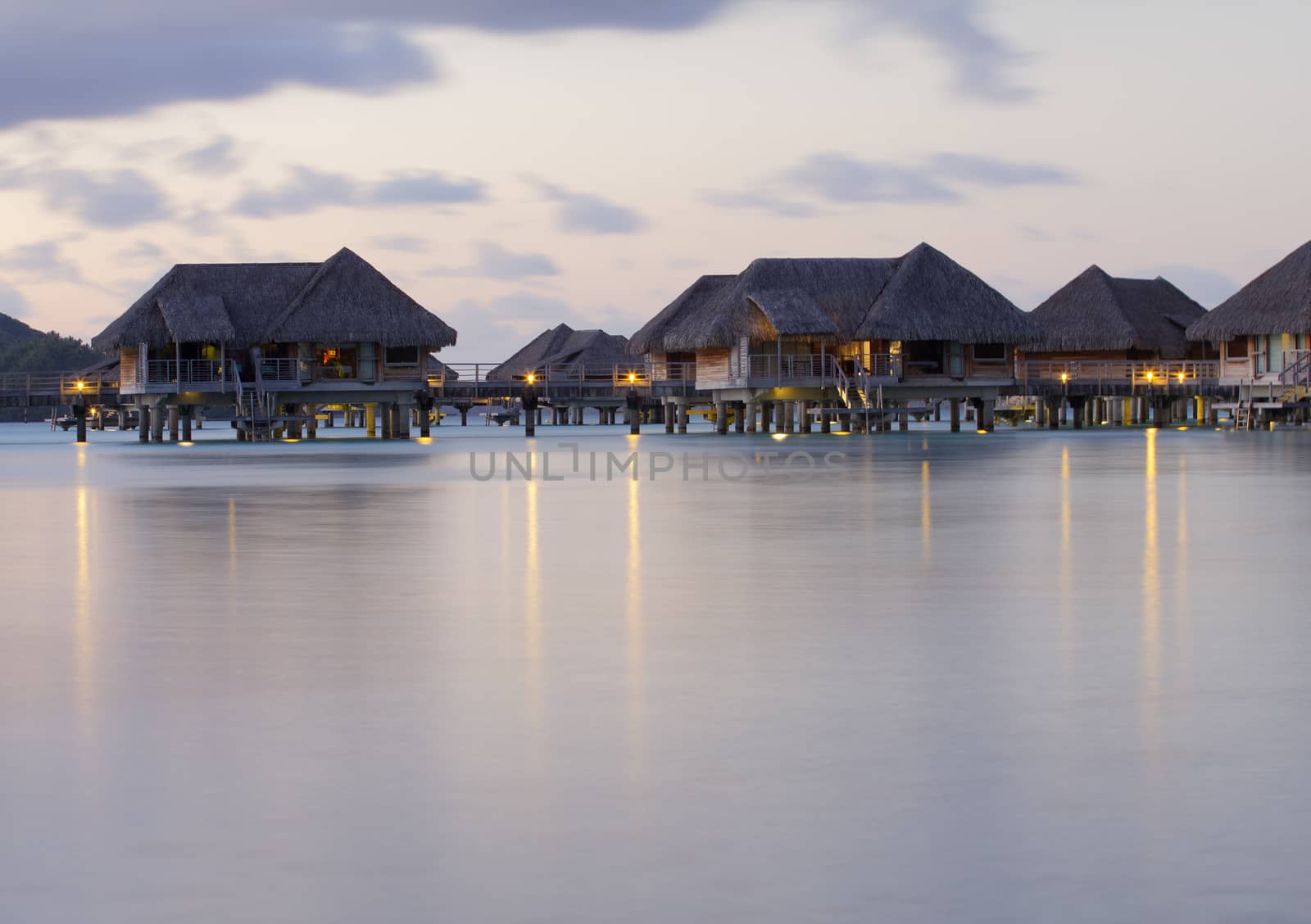 image of  over water bungalows with light at dusk in bora bora