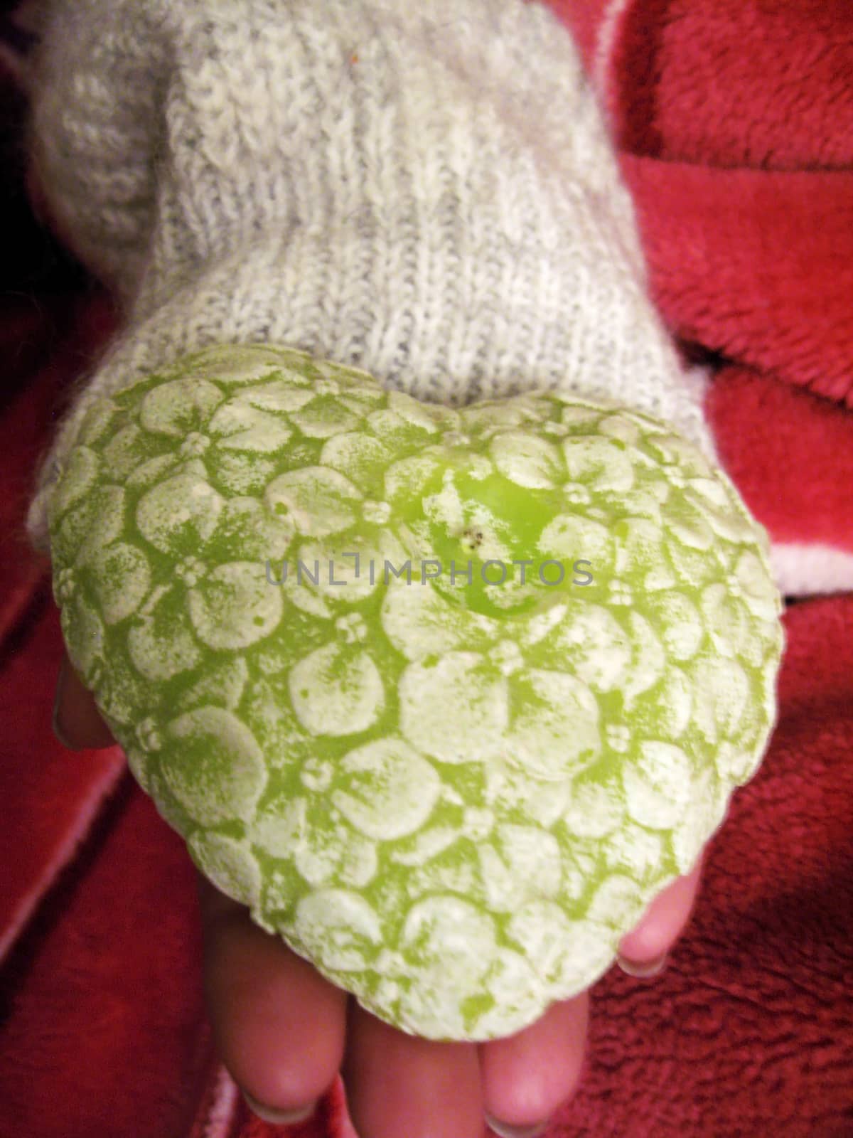 Valentine heart and heart shape candle in woman hands