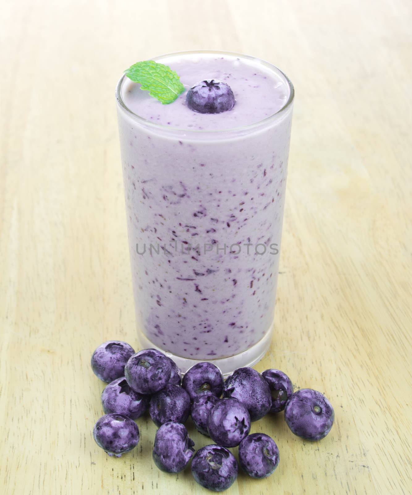 Blueberry smoothie with fresh blueberry on wood