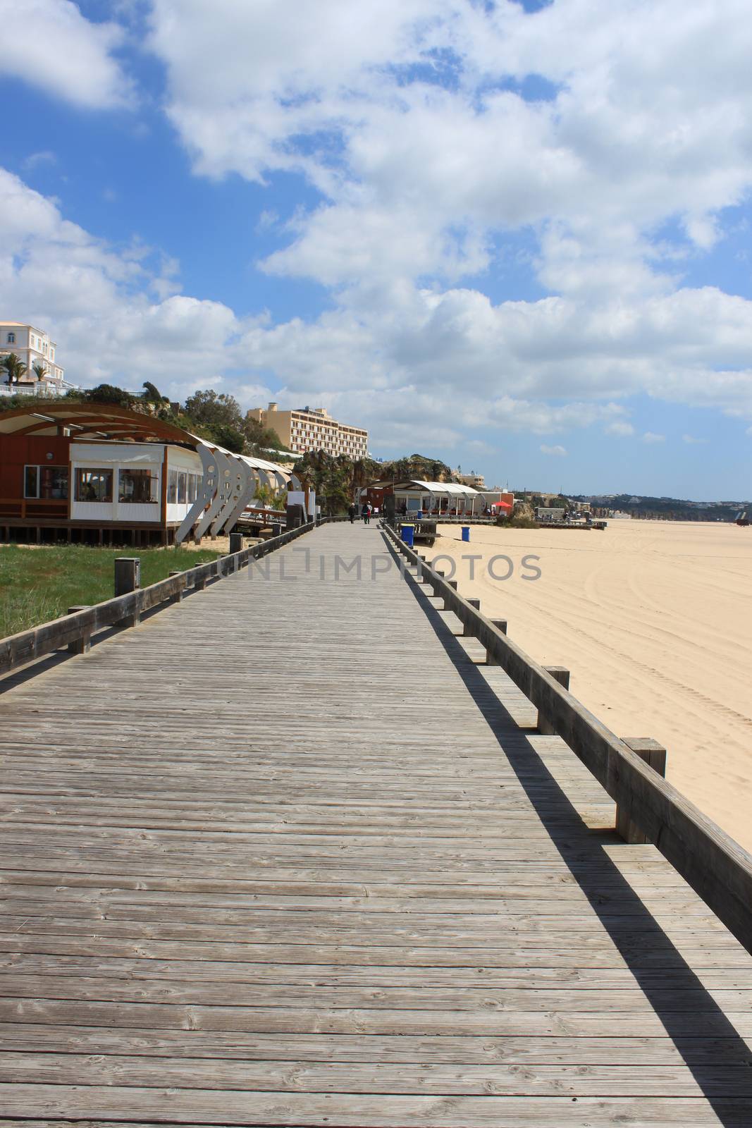 Boardwalk along the golden sandy shored beach and of Praia da Rocha in Algarve, Portugal