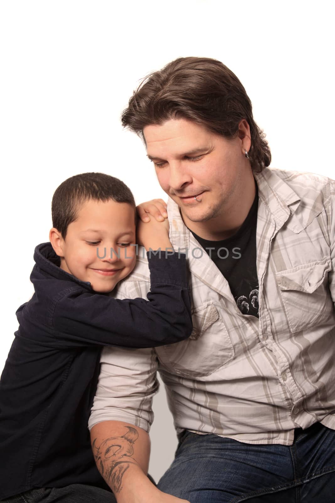 Handome father with tattoos and piercings and his son leaning on him 