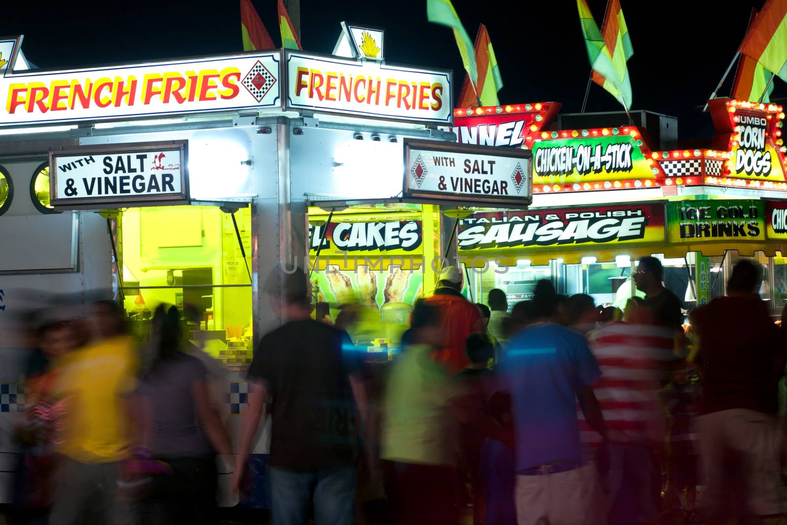 Lawrenceville, GA, USA - September 24, 2011:  Unidentified patrons walk amongst a variety of fast food vendors at the Gwinnett County Fair in Lawrenceville. 