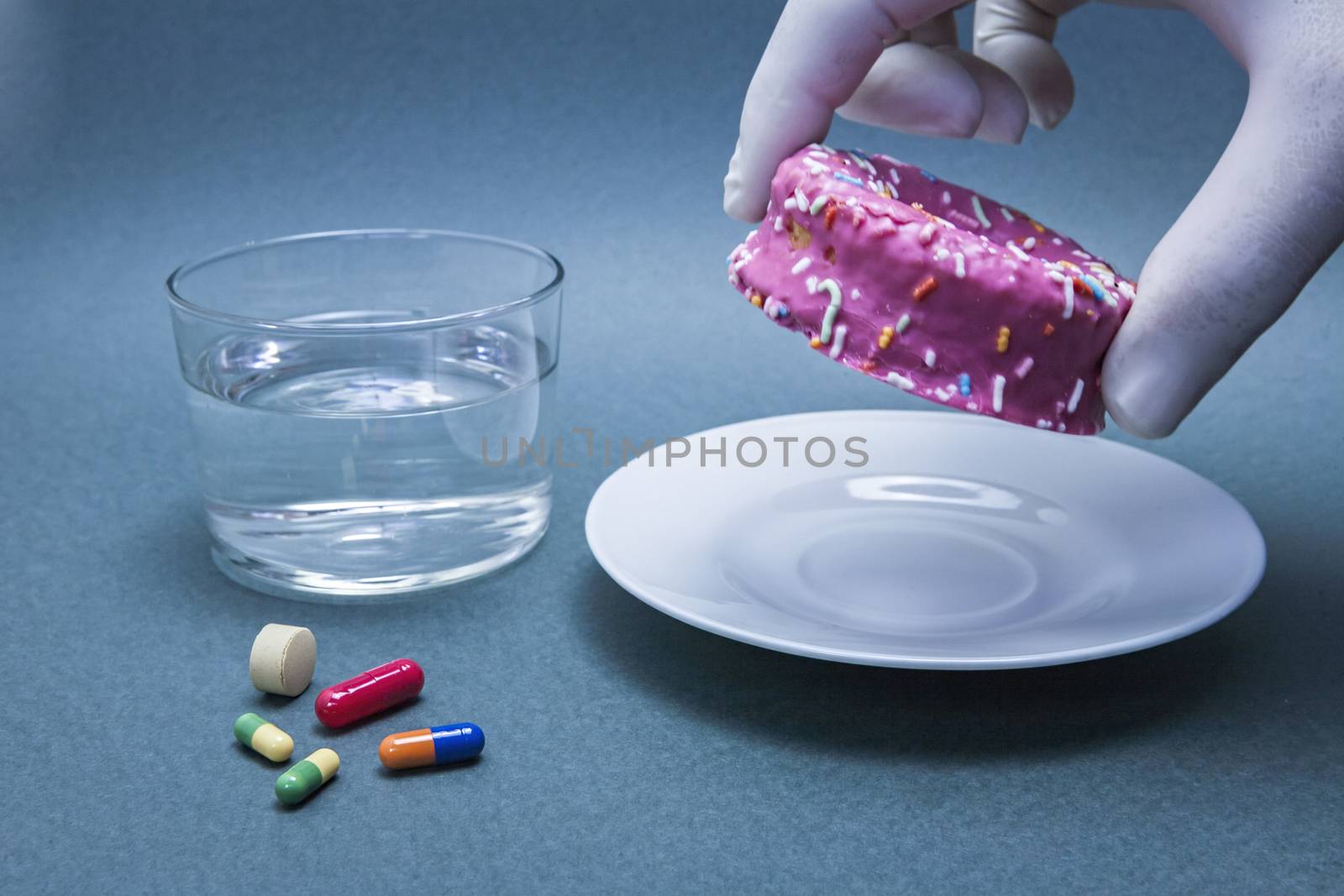 Various medicines to combat diabetes along with a sweet cake, concept of disease of hyperglycemia or diabetes