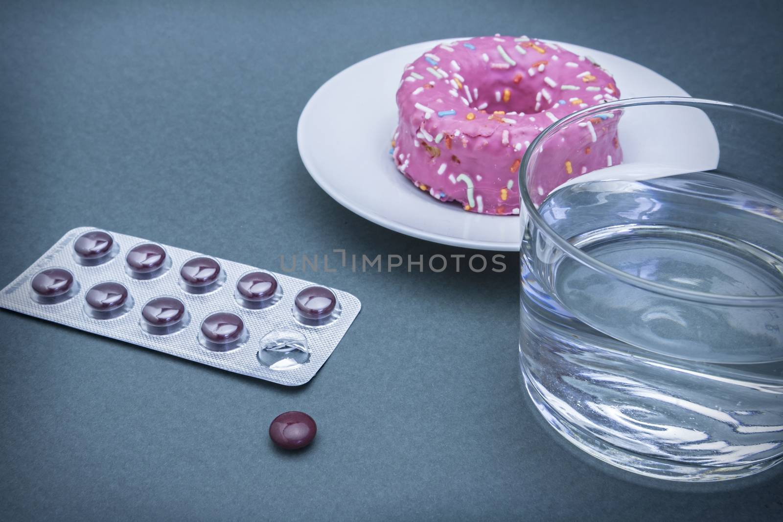 Various medicines to combat diabetes along with a sweet cake, concept of disease of hyperglycemia or diabetes