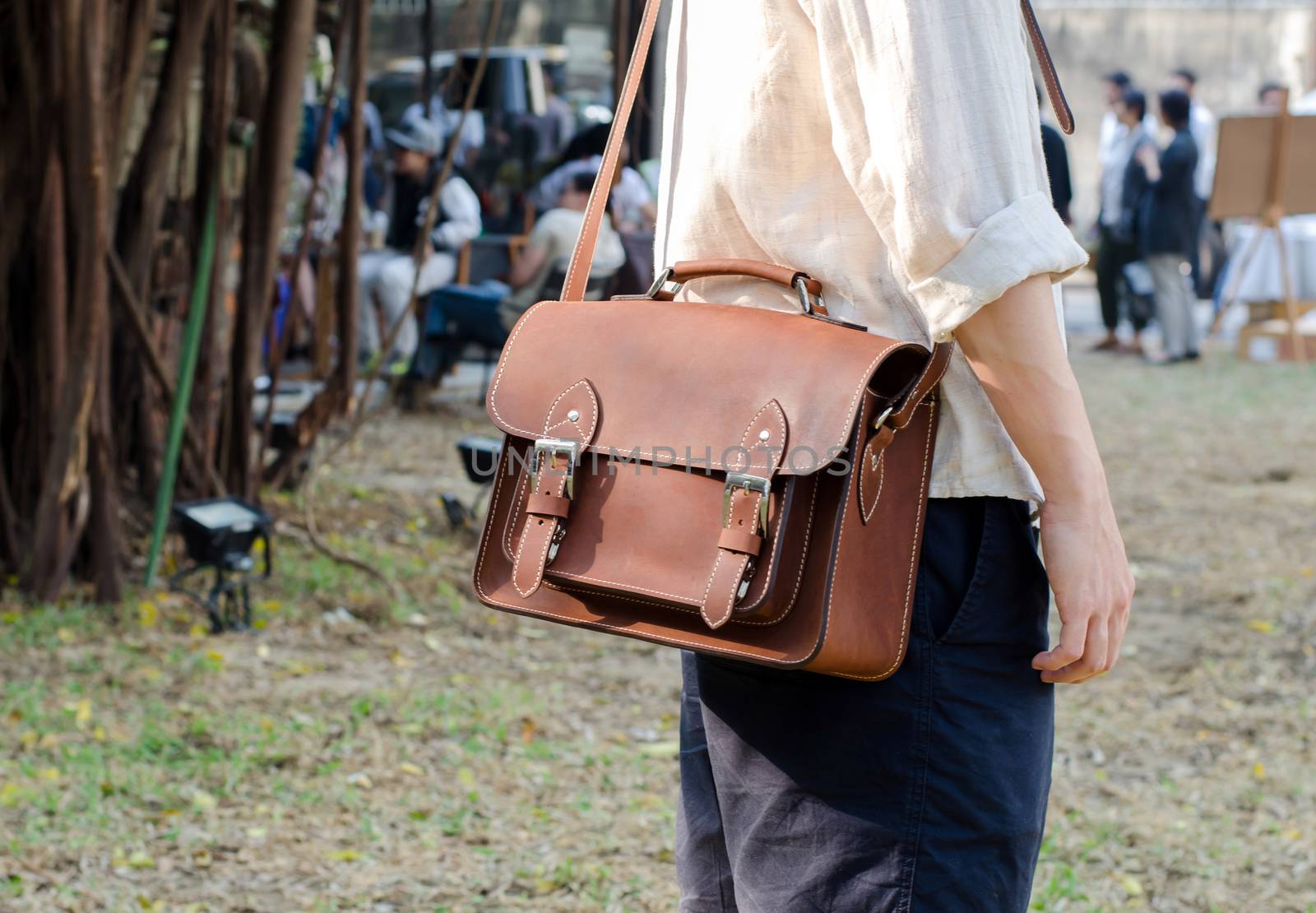 Man with leather bag by siraanamwong