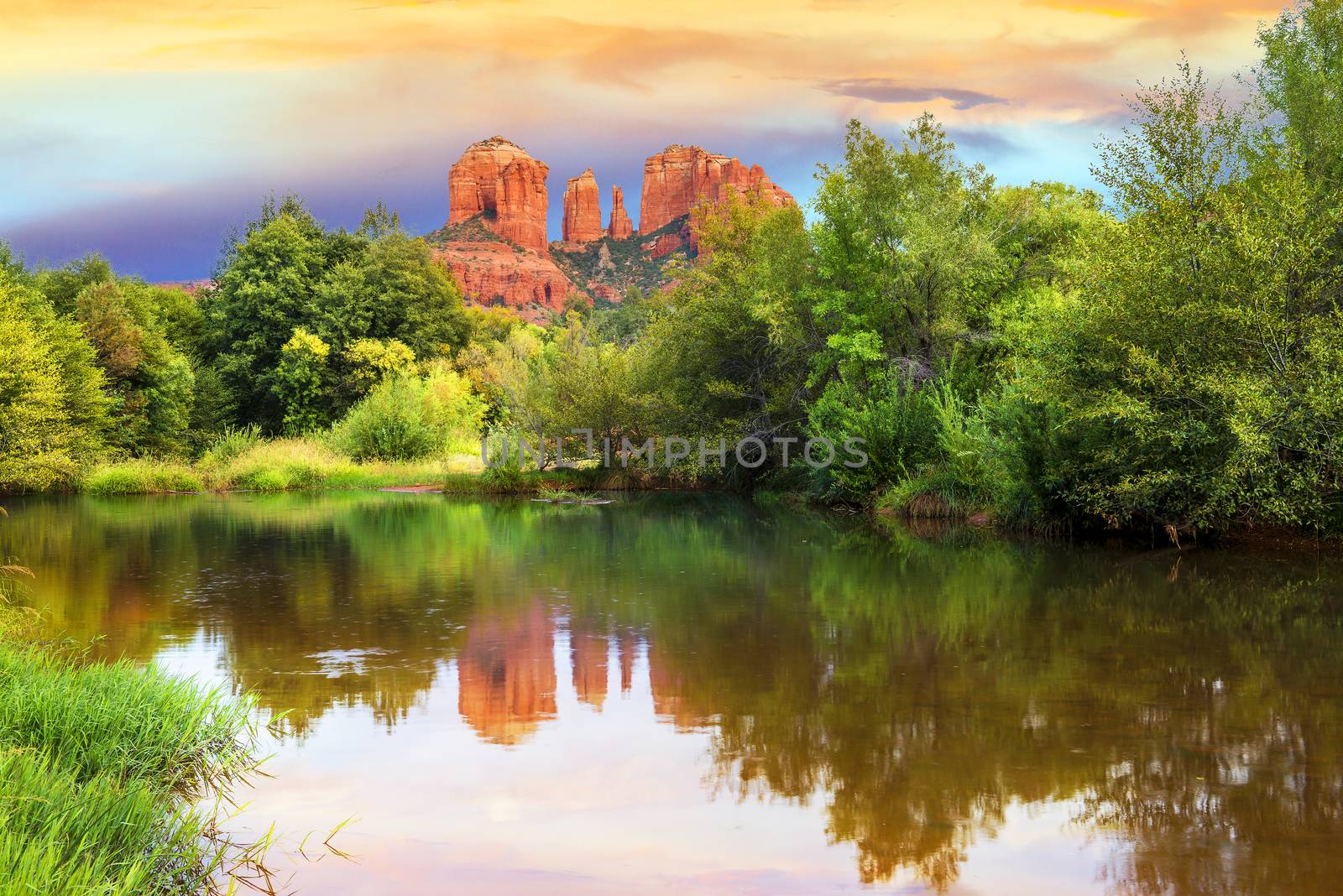 The view of Cathedral Rock in Sedona, Arizona. The towering rock formations stand out like beacons in the dimmed landscape of the Red Rock State Park. 