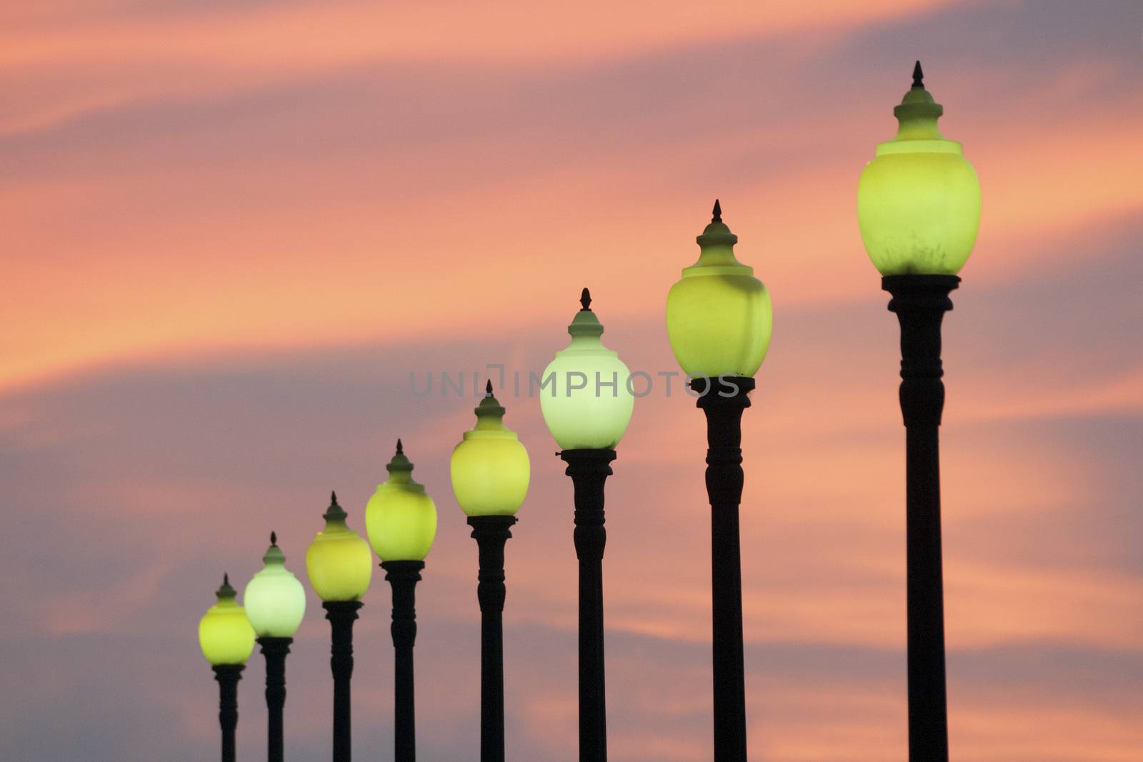 row of classic style city lamps over twilight sky in Barcelona, Spain