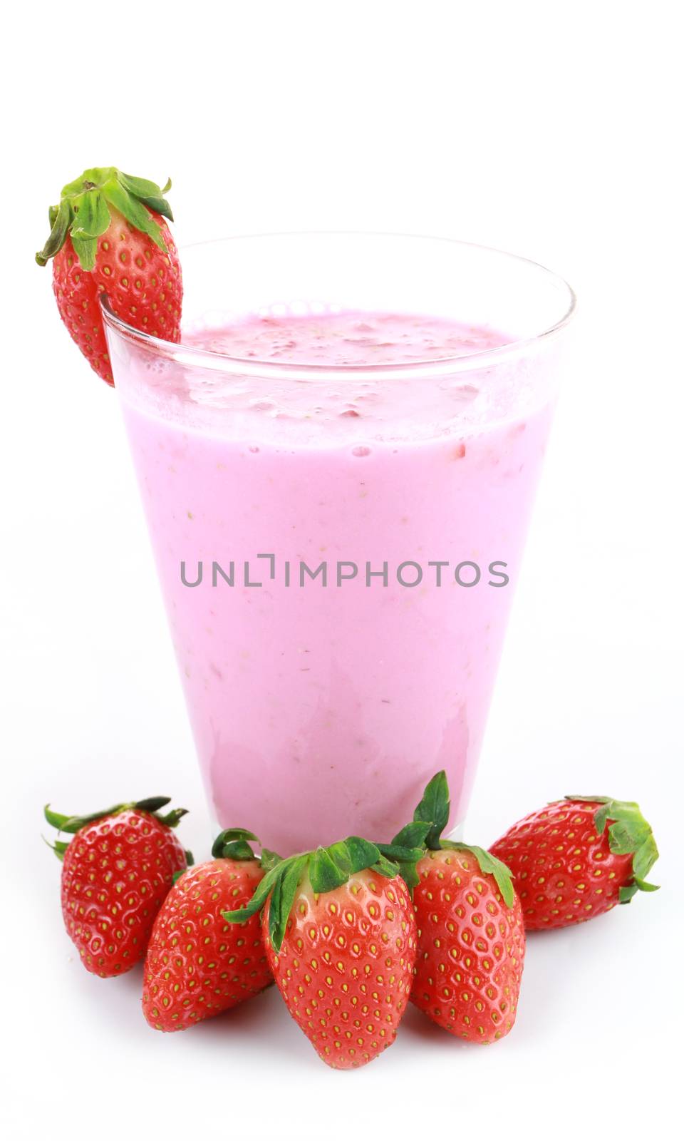 glass of strawberry smoothie on a white wooden background